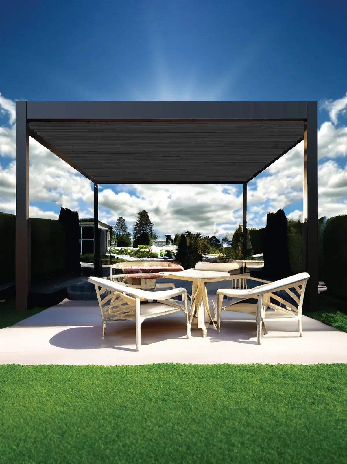 Pergola with grey roof over outdoor seating on a patio. Green grass in foreground, blue sky.