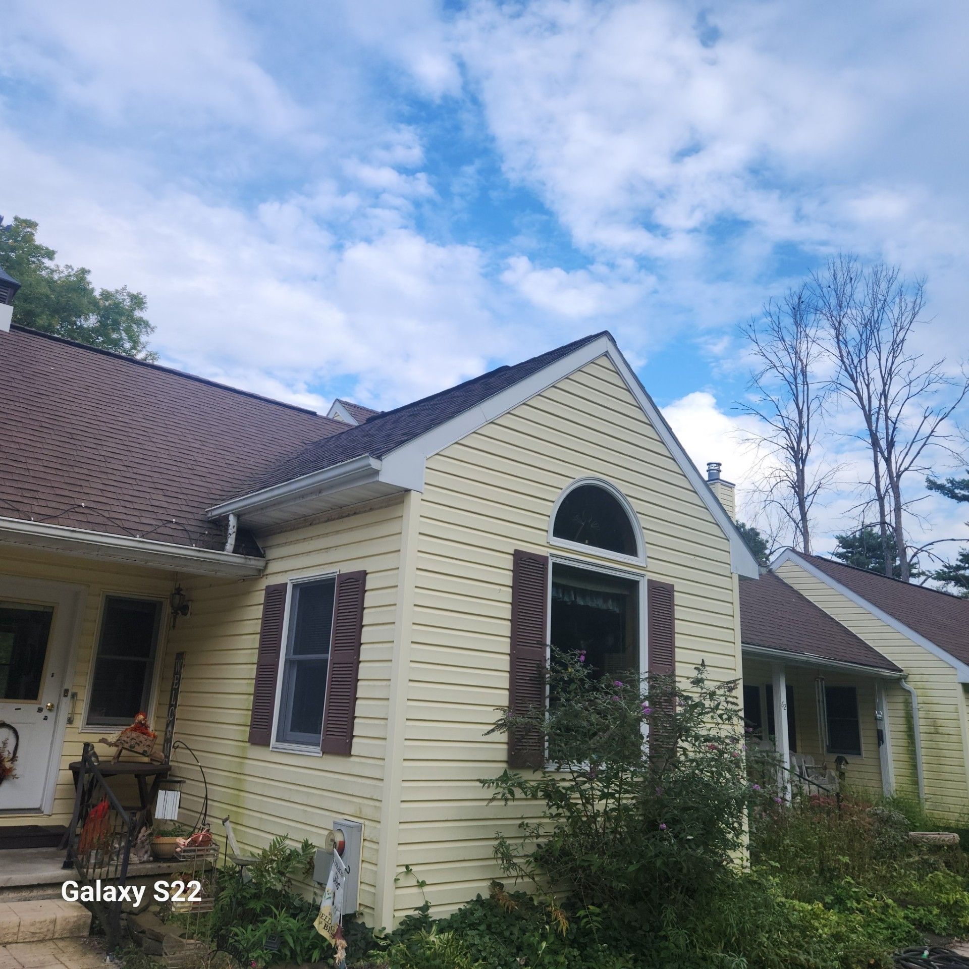 A house with a galaxy s22 phone in front of it