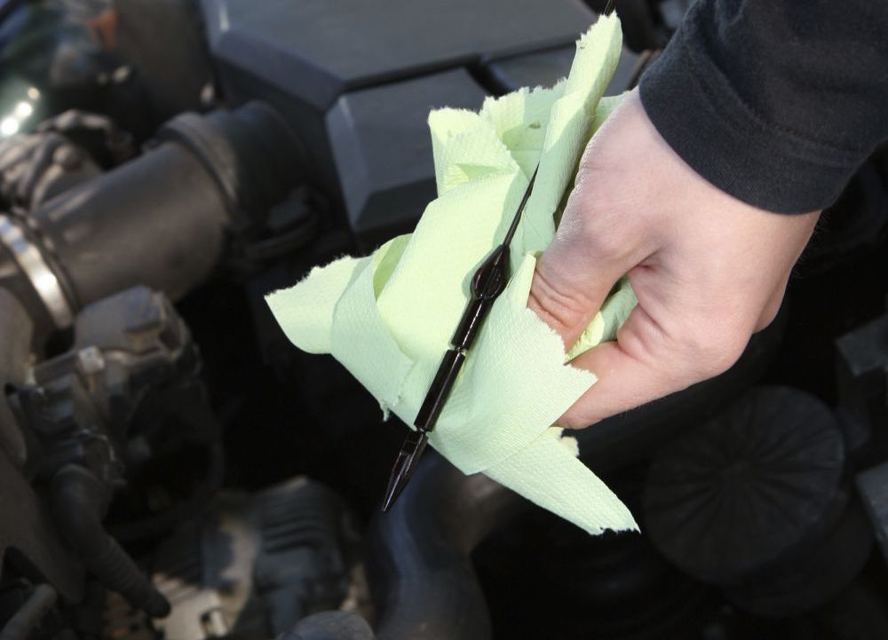 checking oil as part of our motor repair services in Christchurch