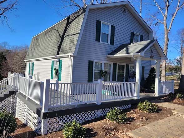 home with a white wraparound deck