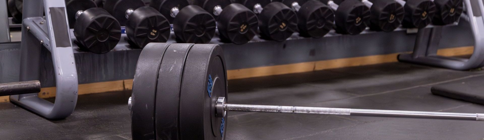 Loaded barbell on gym floor