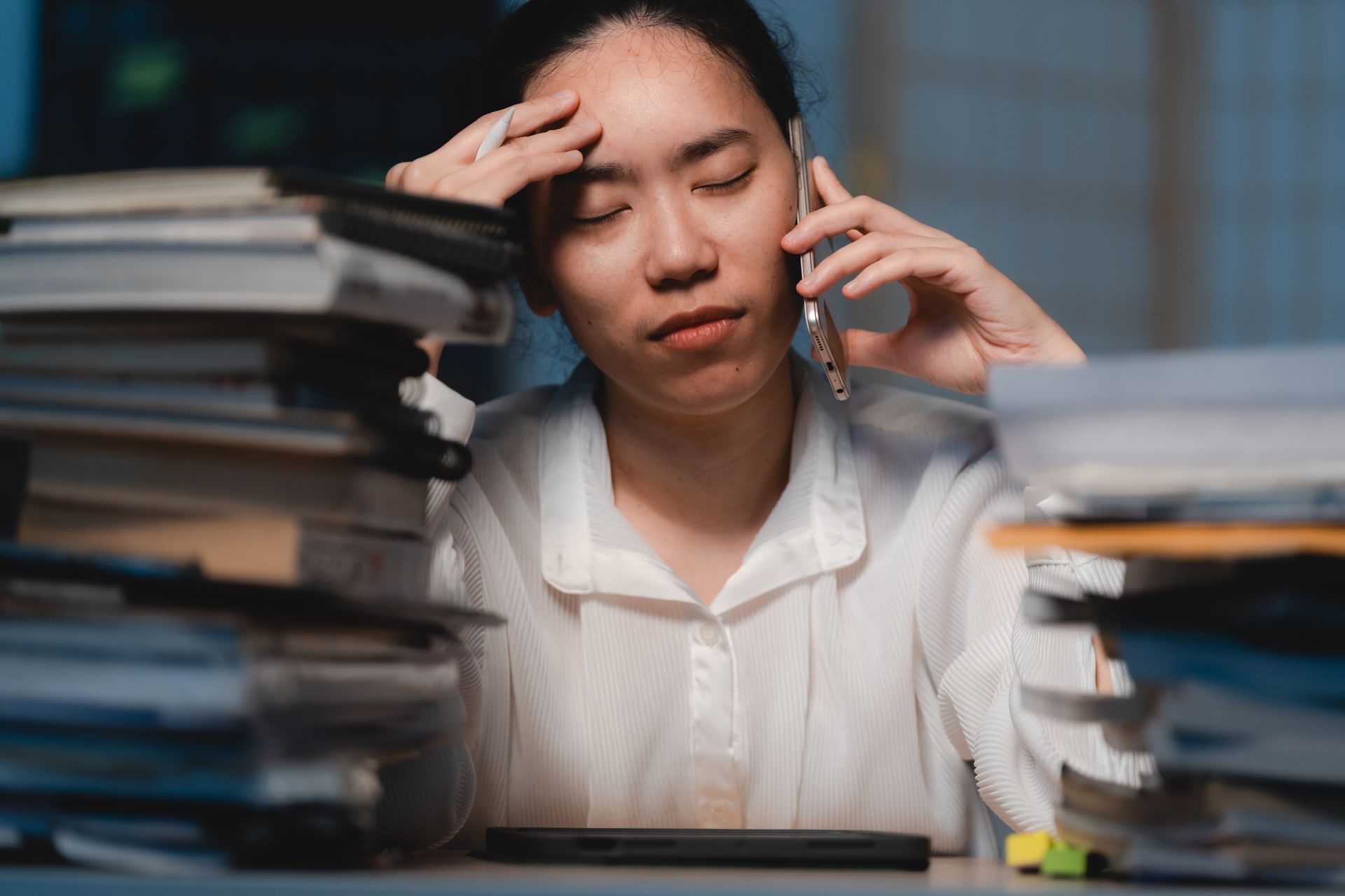 overwhelmed woman with lots of work on her desk
