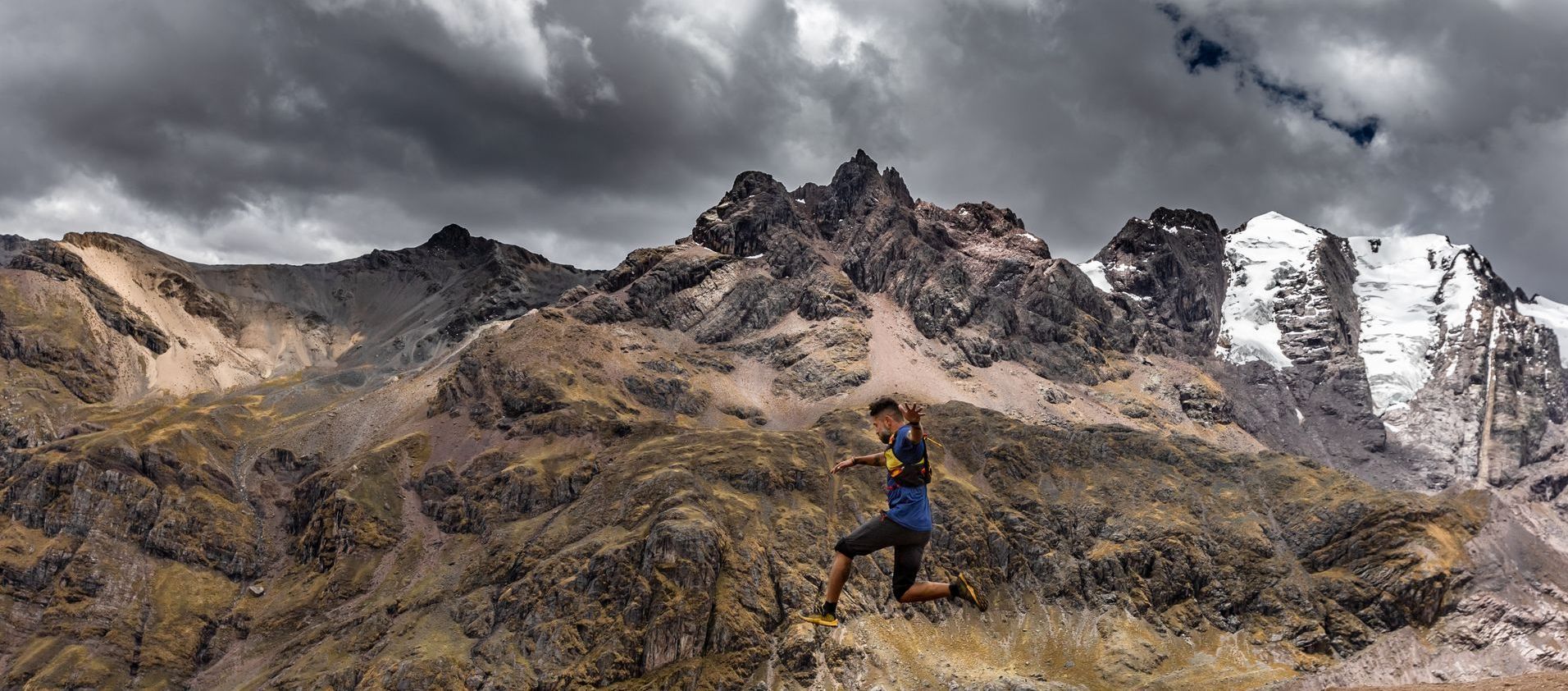Man trail running over rough terrain