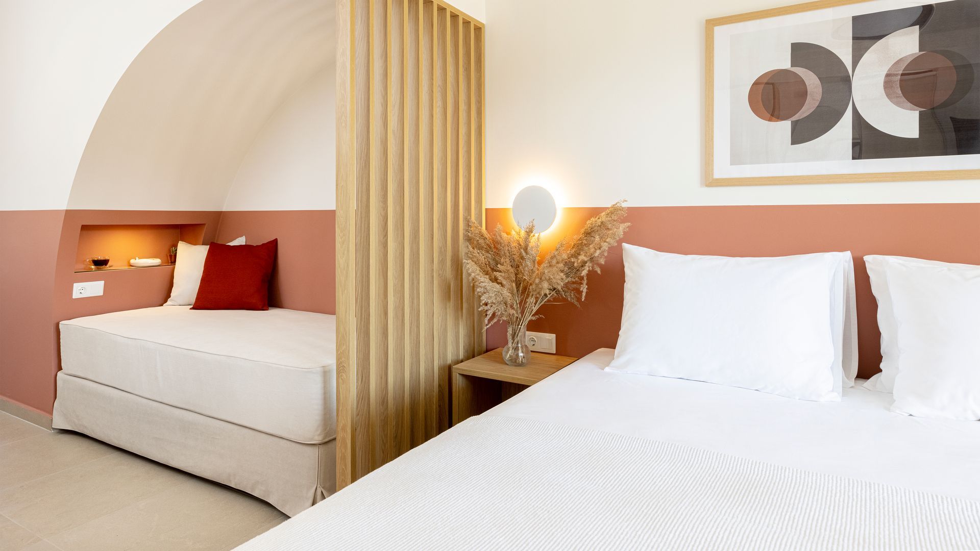 A bedroom with a bed and a smaller bed next to it.