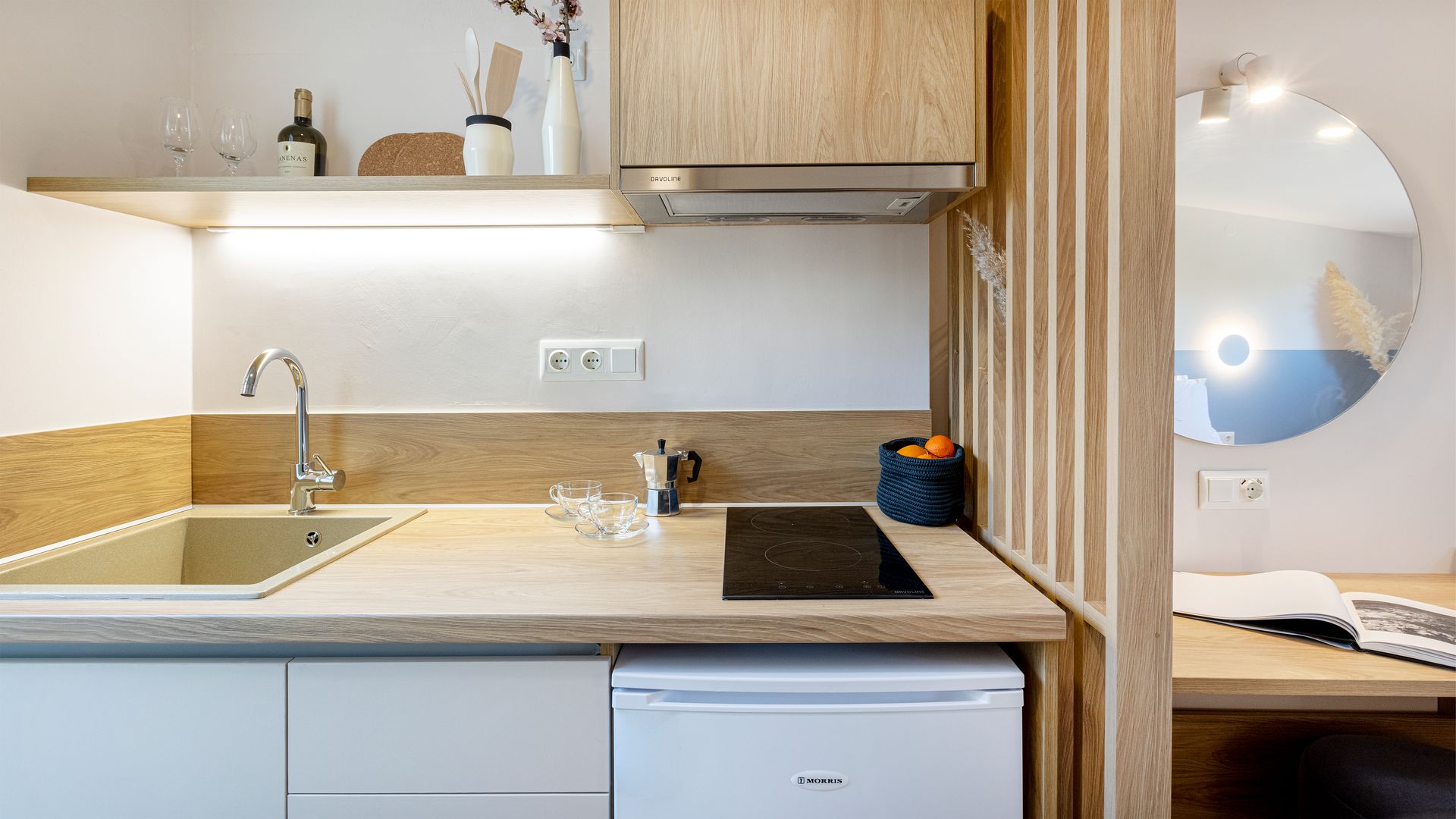 A small kitchen with a sink , stove , refrigerator and dishwasher.