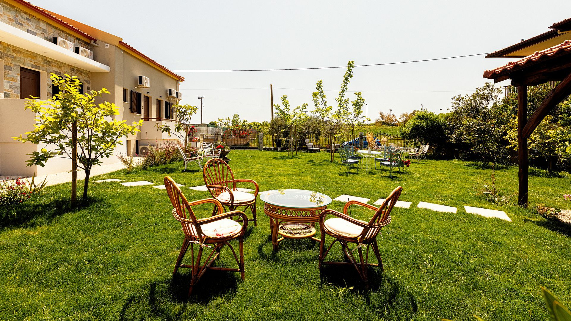 A lawn with a table and chairs in it