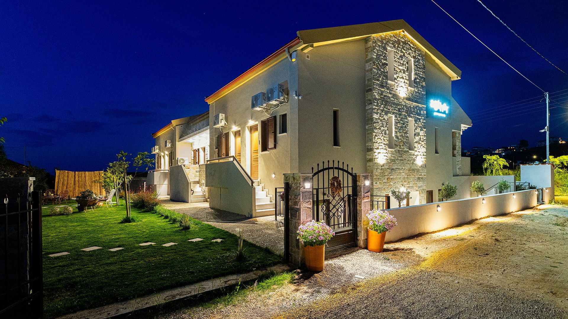 A large white house is lit up at night.
