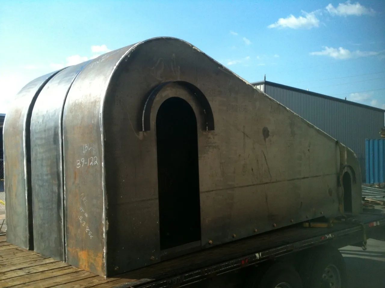 A large piece of metal is sitting on top of a truck.