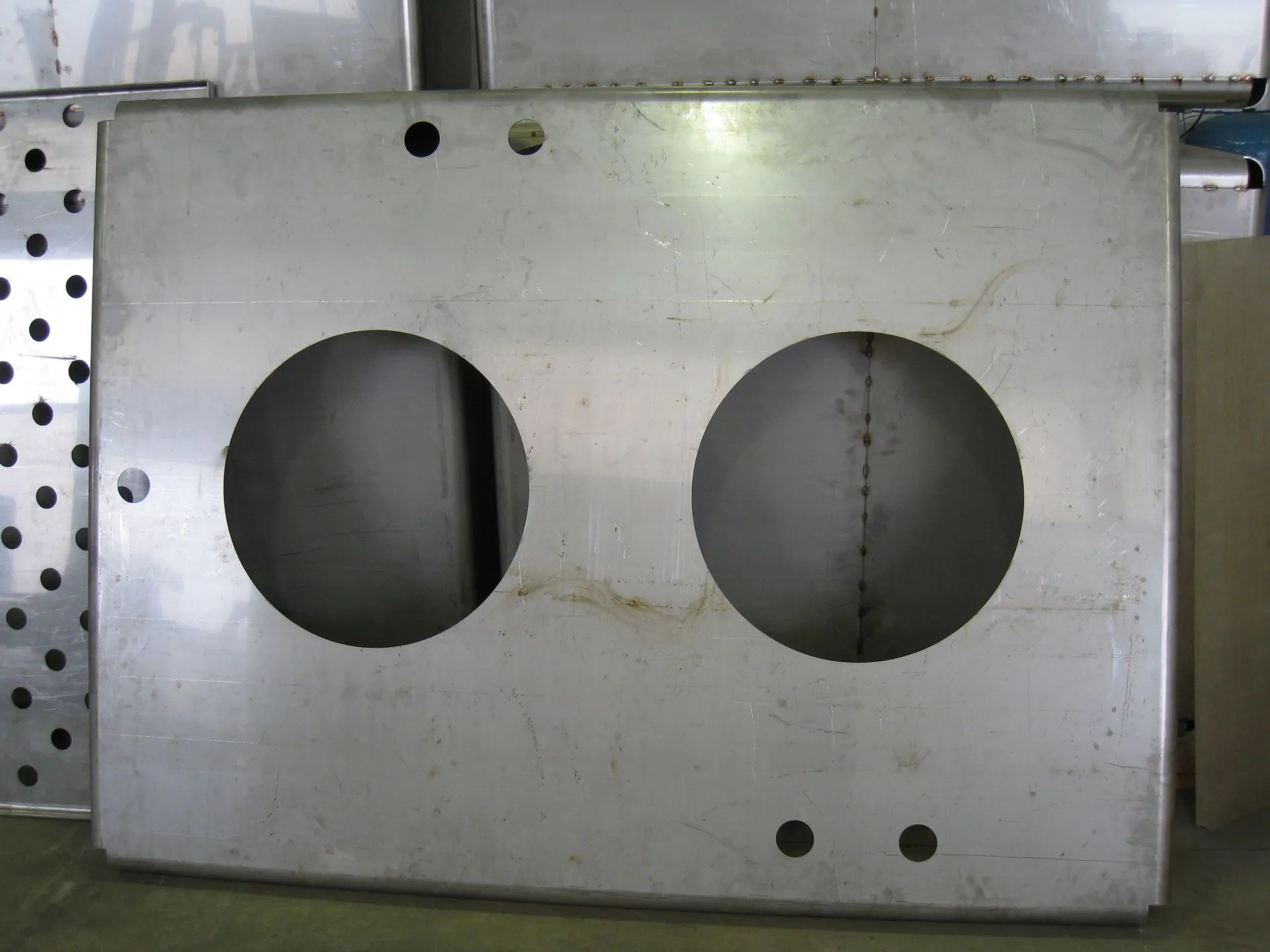 A piece of metal with two holes in it