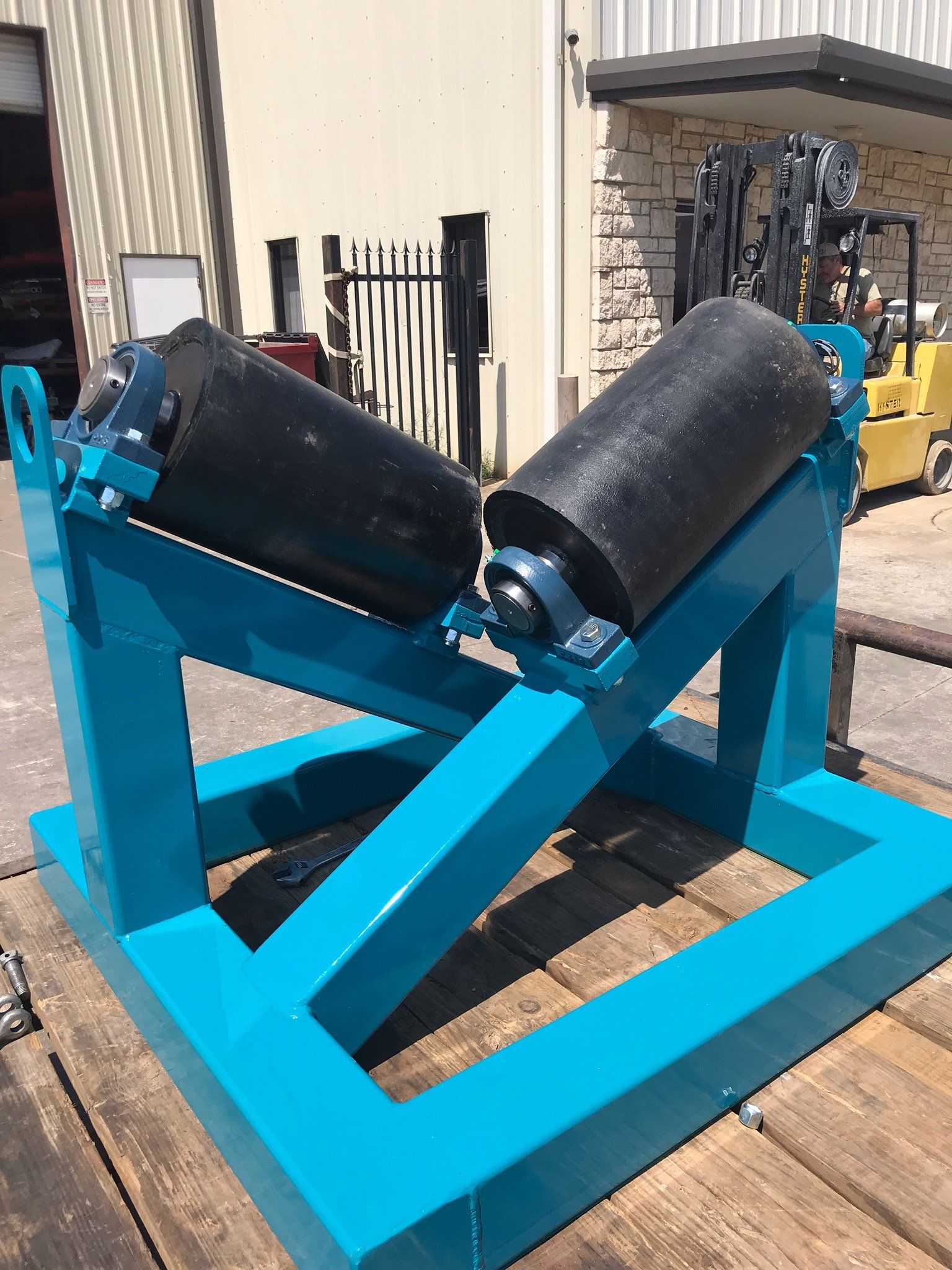 A blue machine is sitting on top of a wooden table.