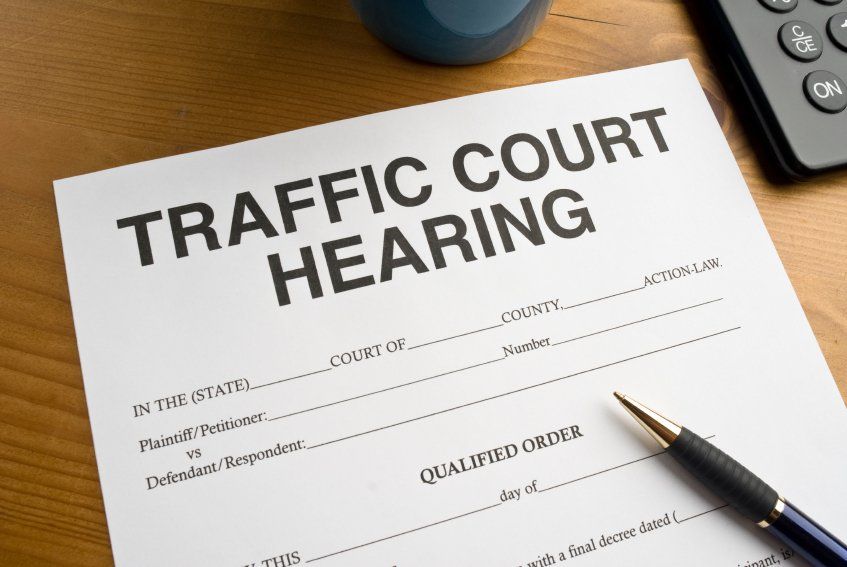 A piece of paper that says traffic court hearing on it