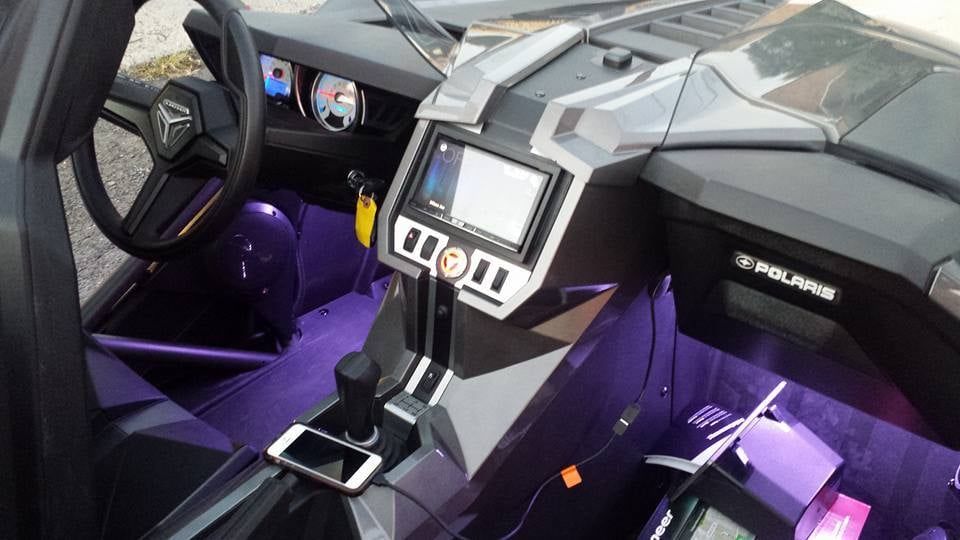 The interior of a polaris slingshot with purple lights