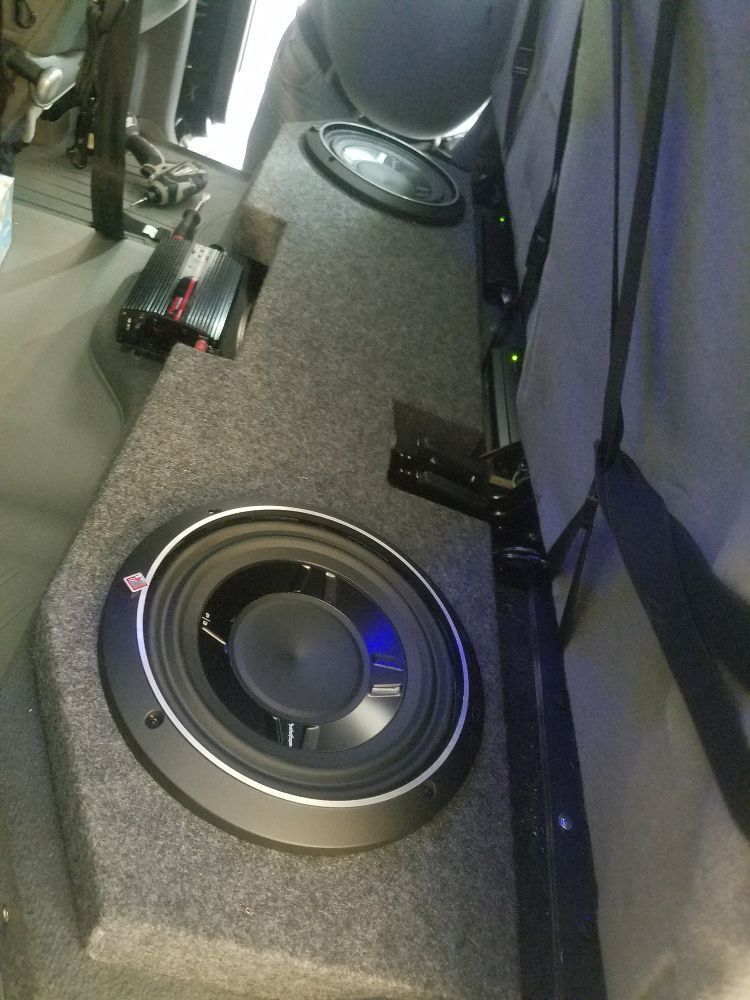 A subwoofer is sitting in the back of a truck.