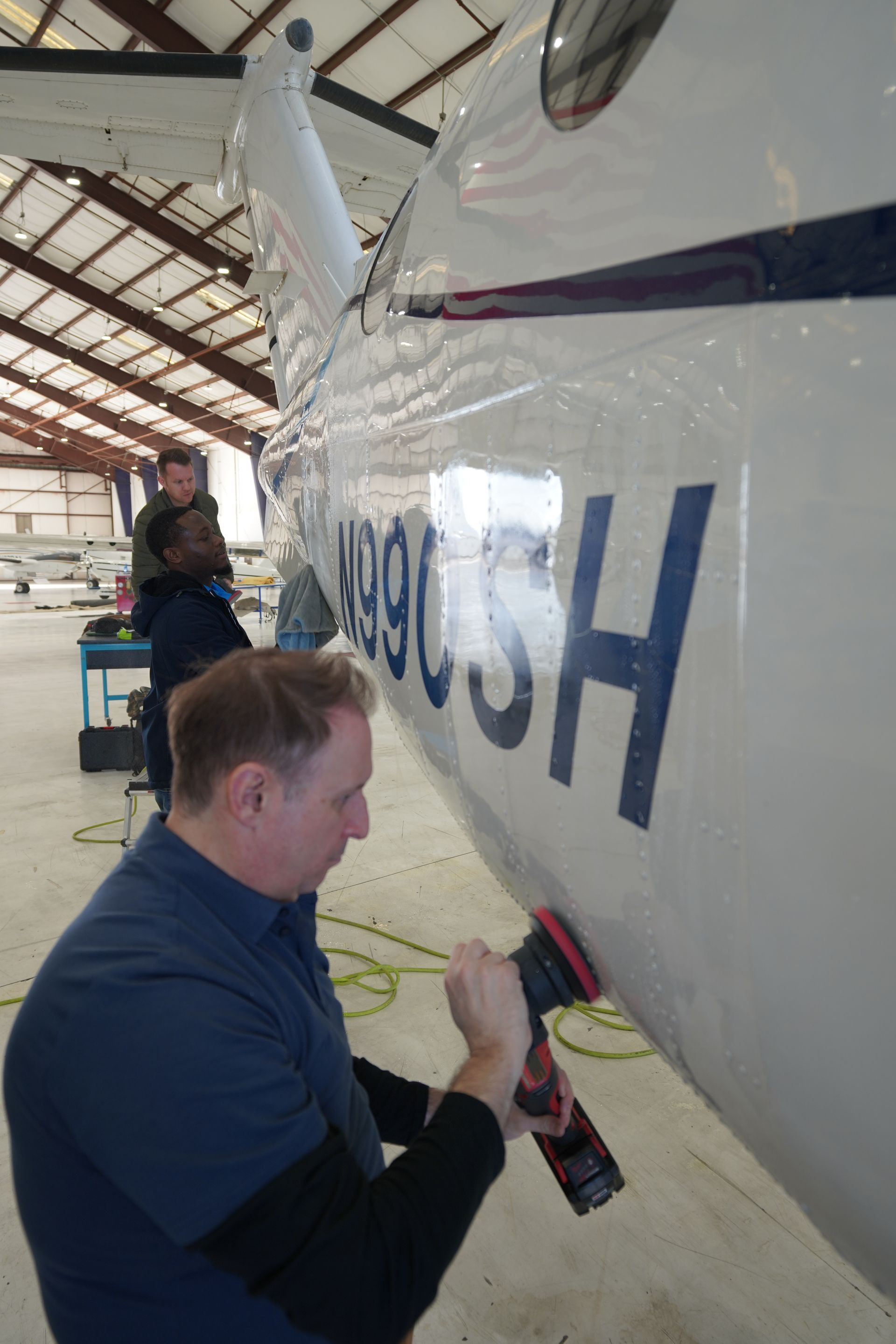 Aircraft exterior cleaning inside Florida hangar