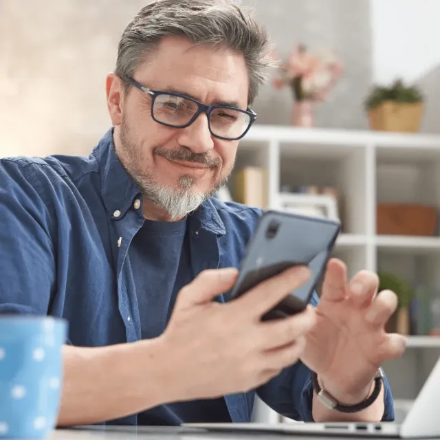 Photo of a Man Looking at His Phone