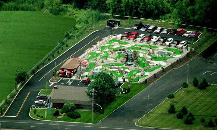 An aerial view of a mini golf course and parking lot