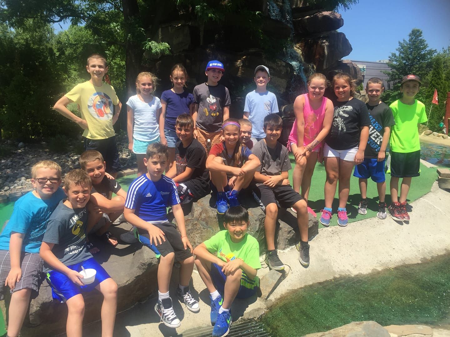 A group of children posing for a picture on a golf course