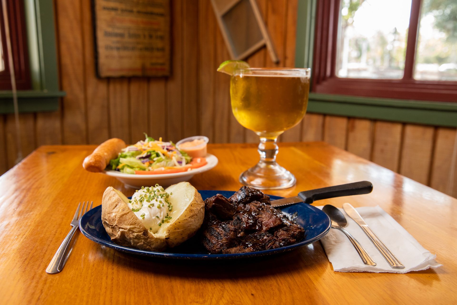 A plate of food and a glass of beer on a table