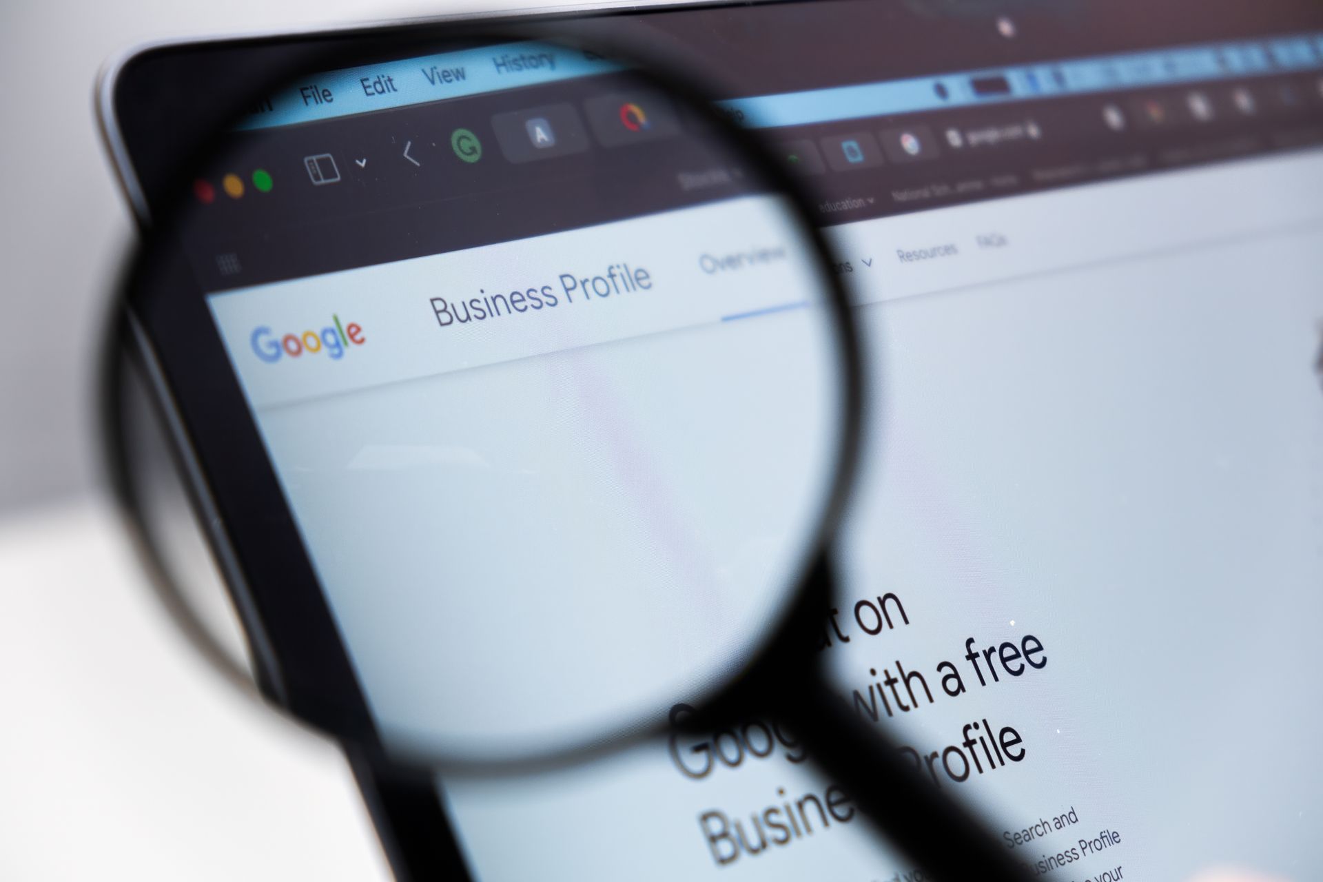 A magnifying glass is looking at a google business profile page