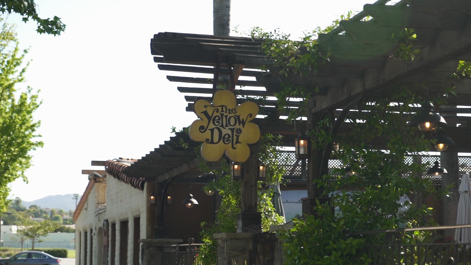 A sign for a restaurant called the yellow doll