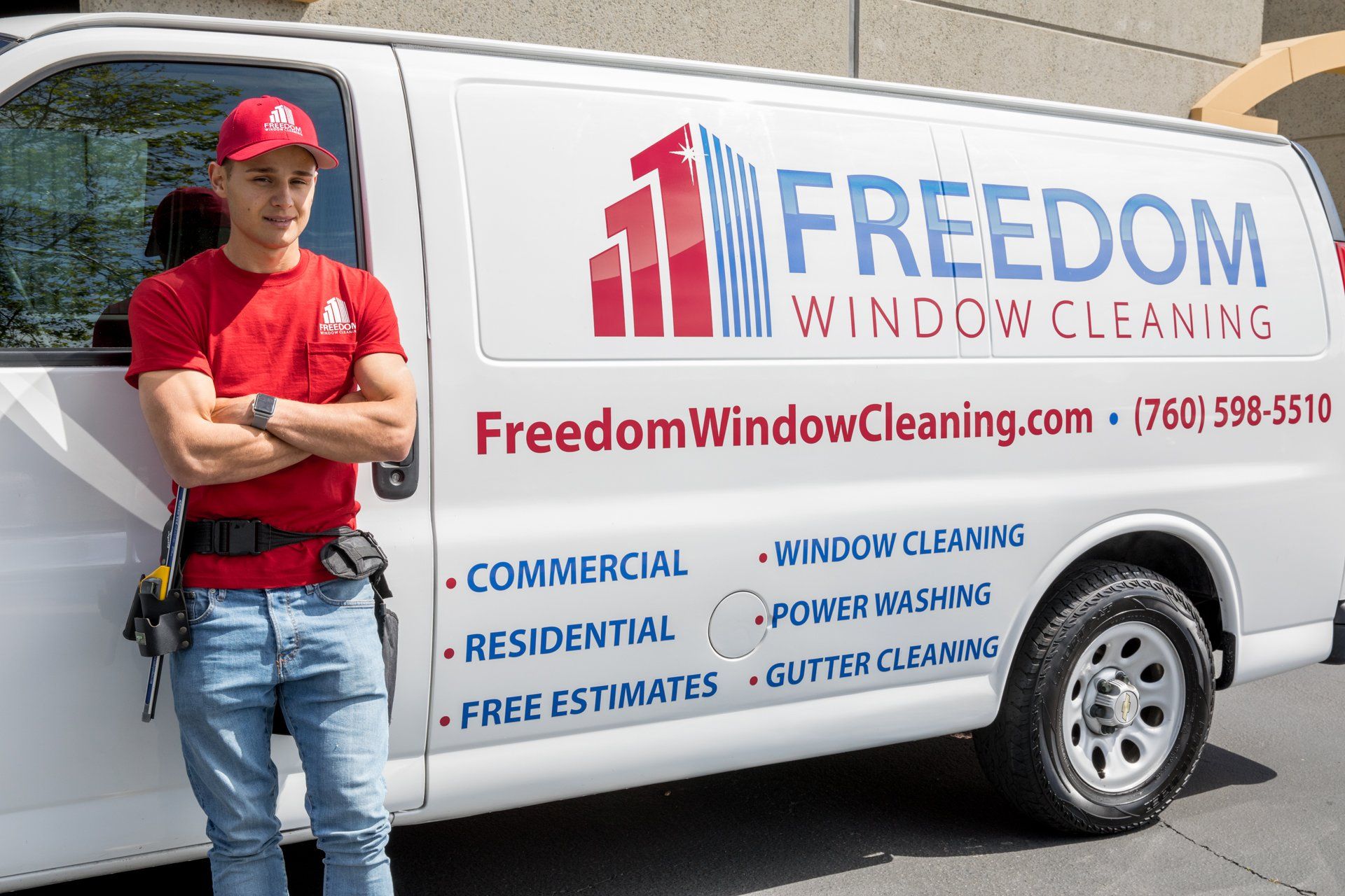 A man standing in front of a freedom window cleaning van