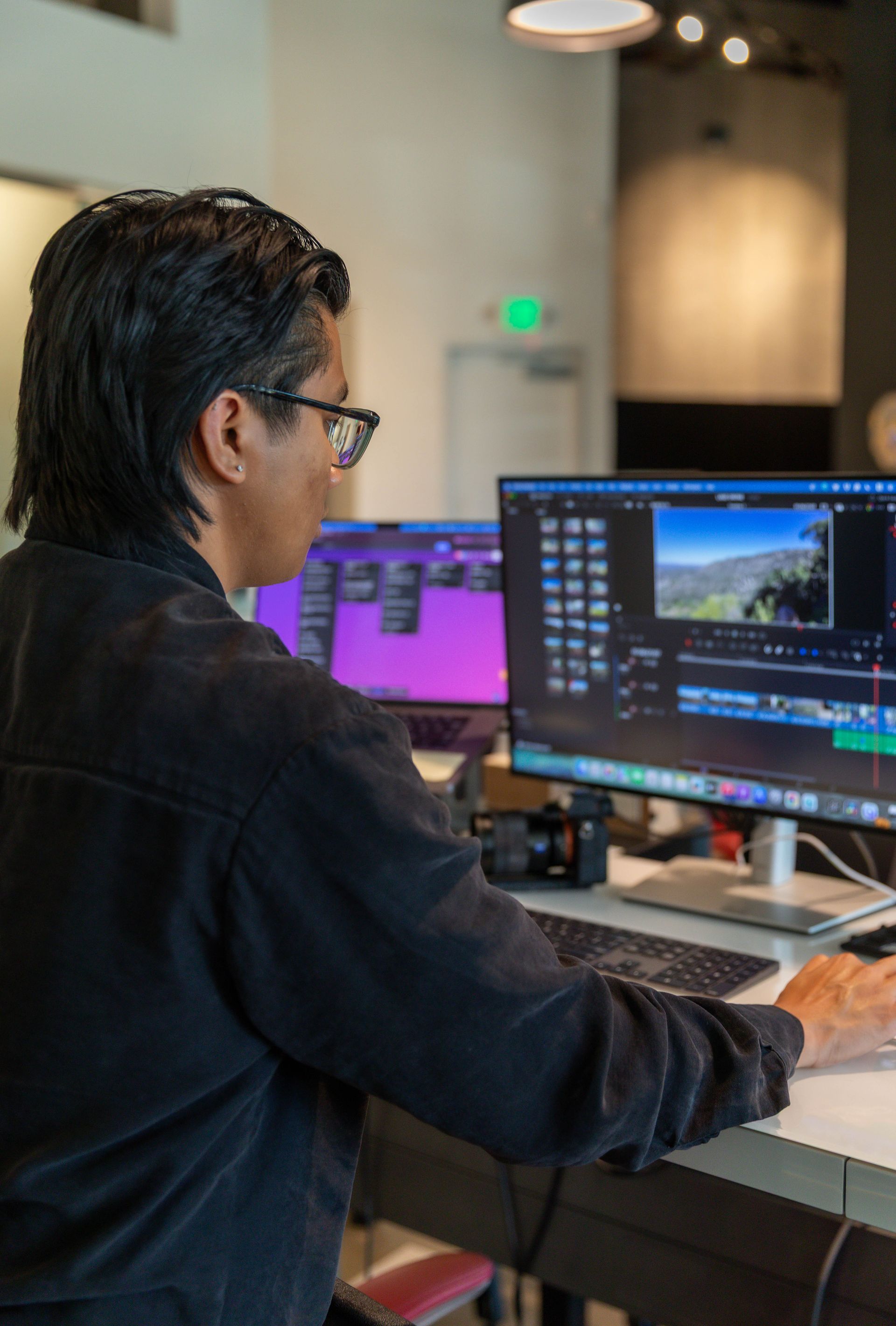 A person is taking a picture of a woman on a yoga mat