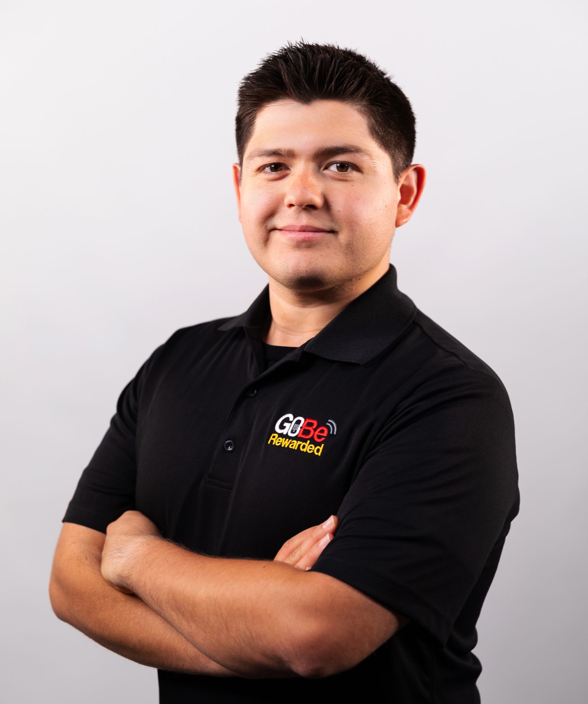 A man with his arms crossed wearing a black shirt that says gse on it