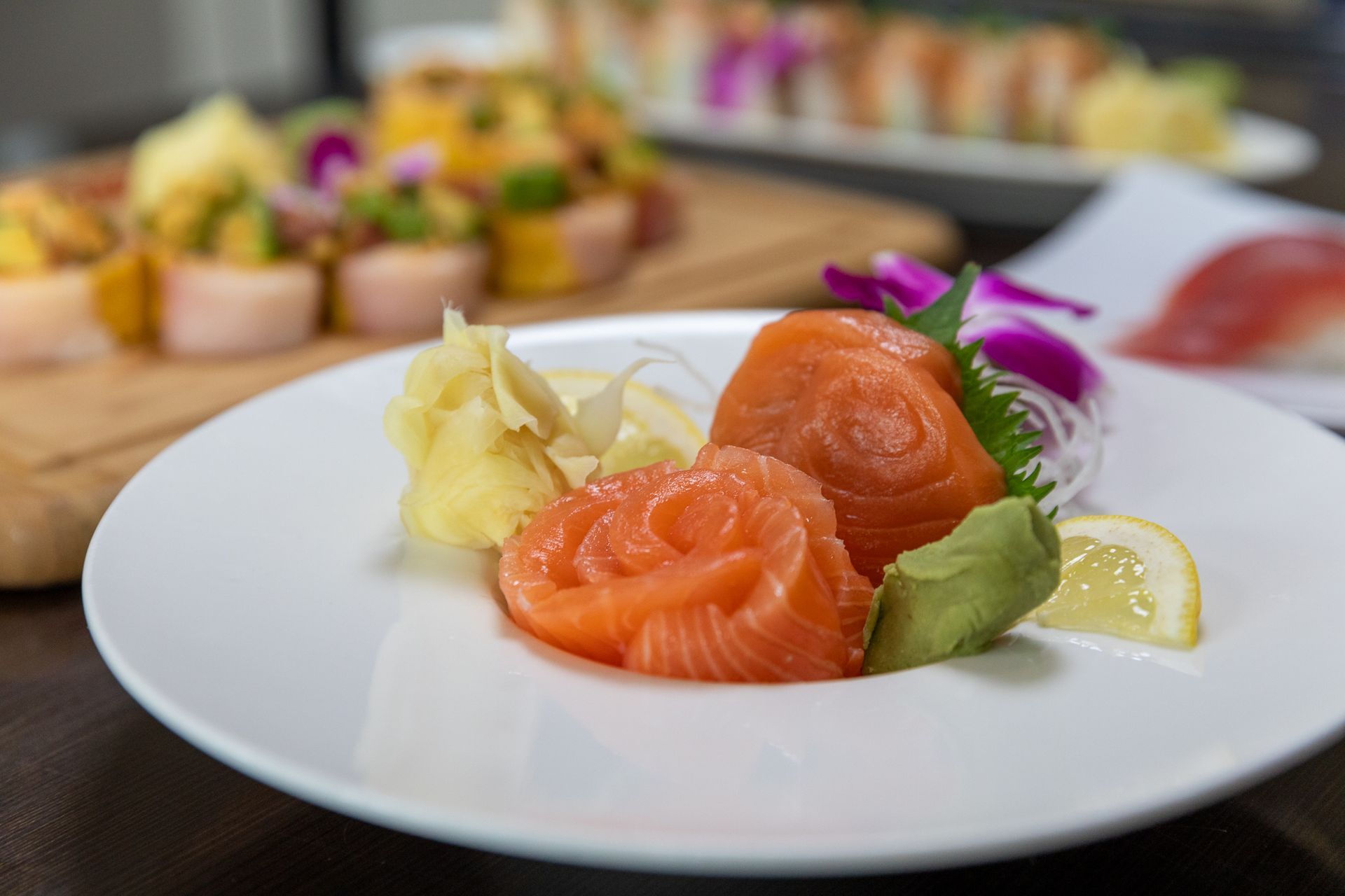 A close up of a plate of food with salmon and avocado