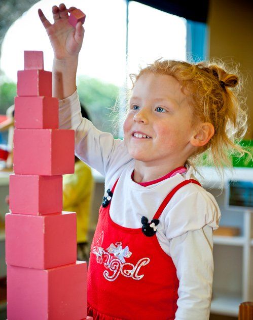 Little girl building blocks