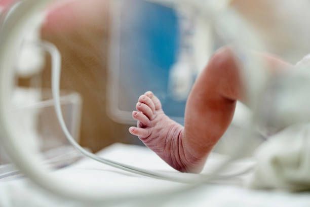 A close up of a baby foot in an incubator