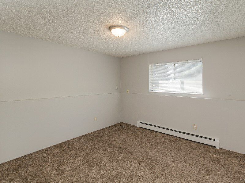 Carpeted Bedroom | Parkwood Place in Greenly, CO