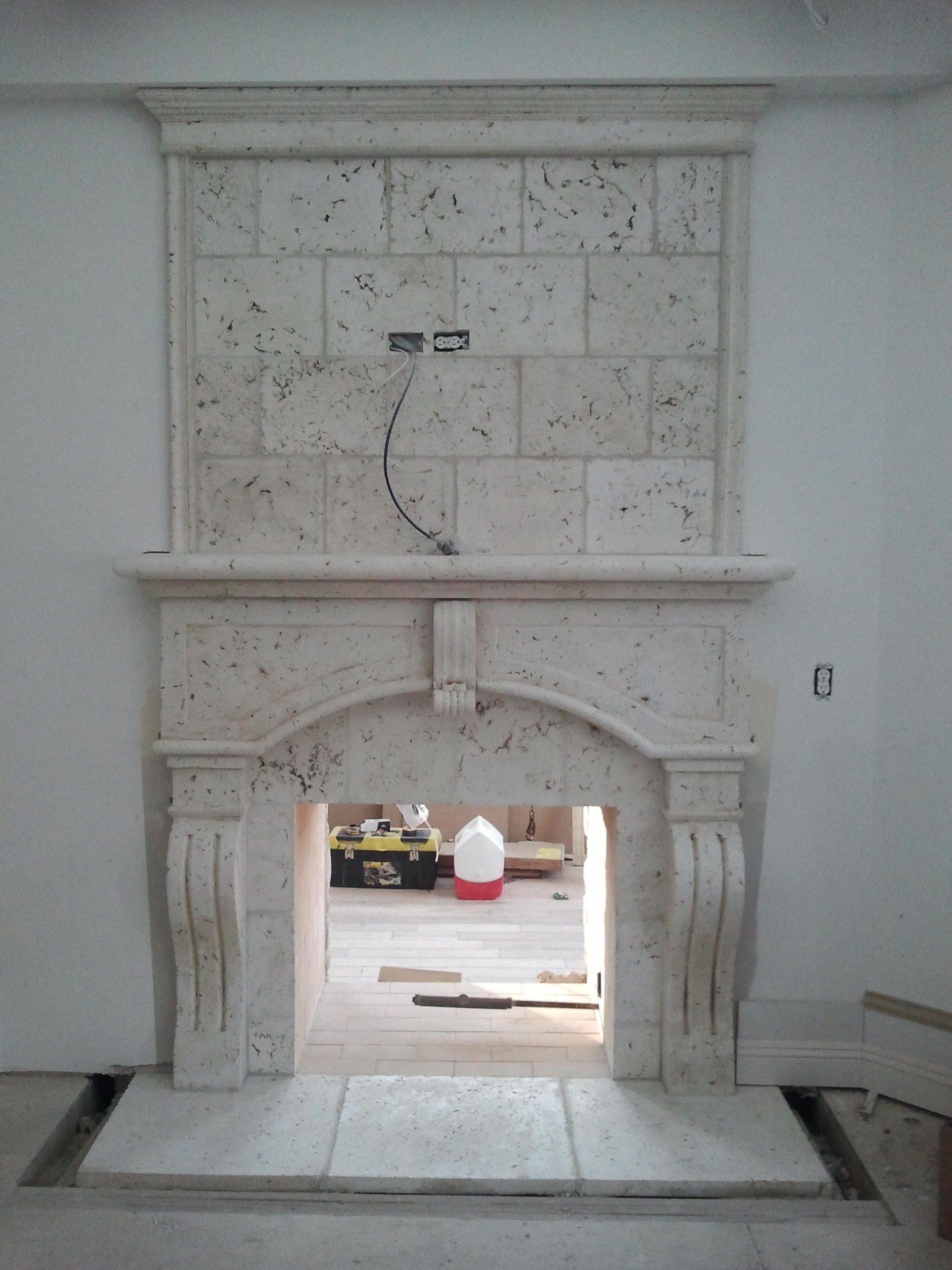 A fireplace with a brick wall behind it