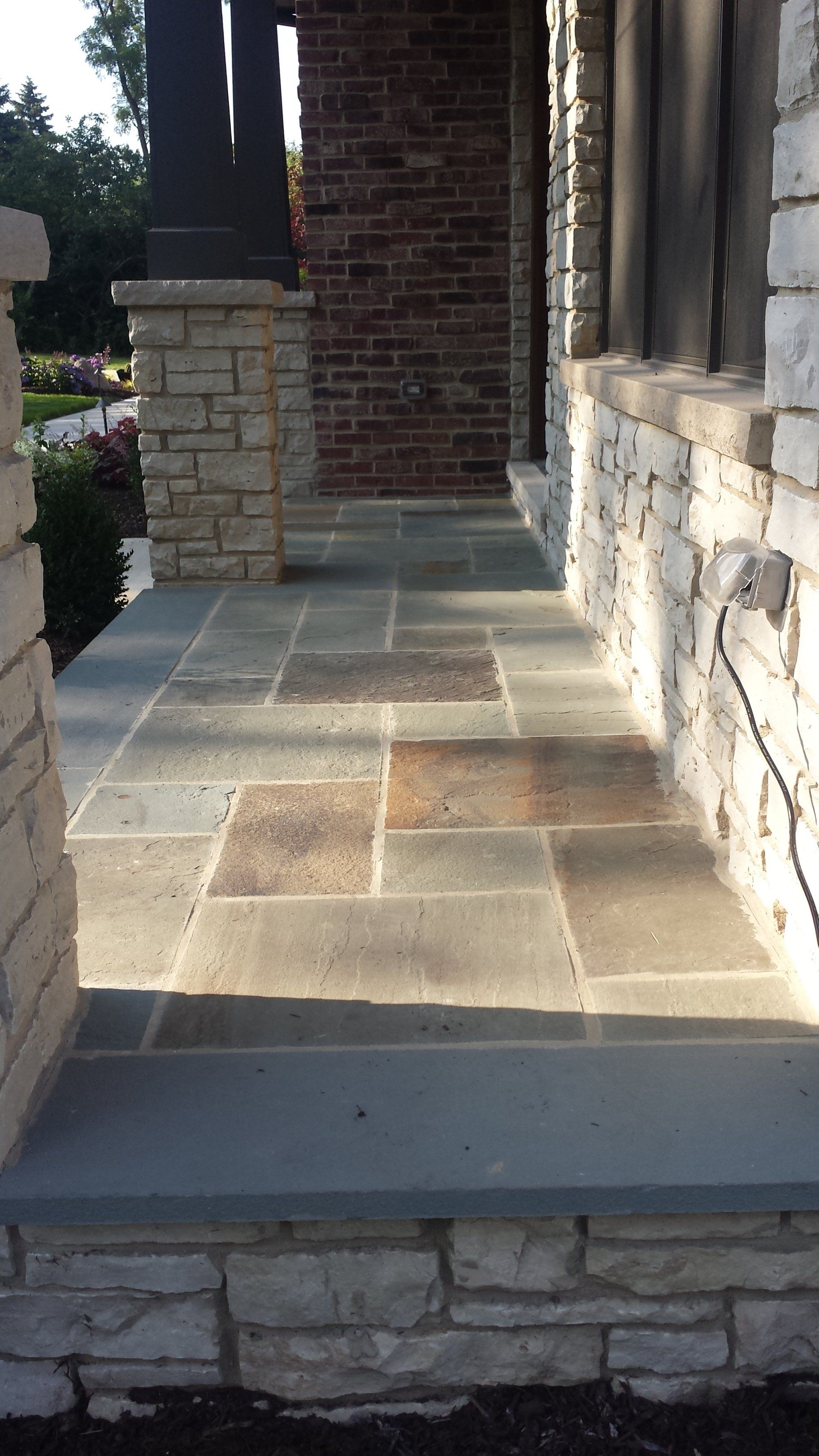 A stone walkway leading to the front door of a house.