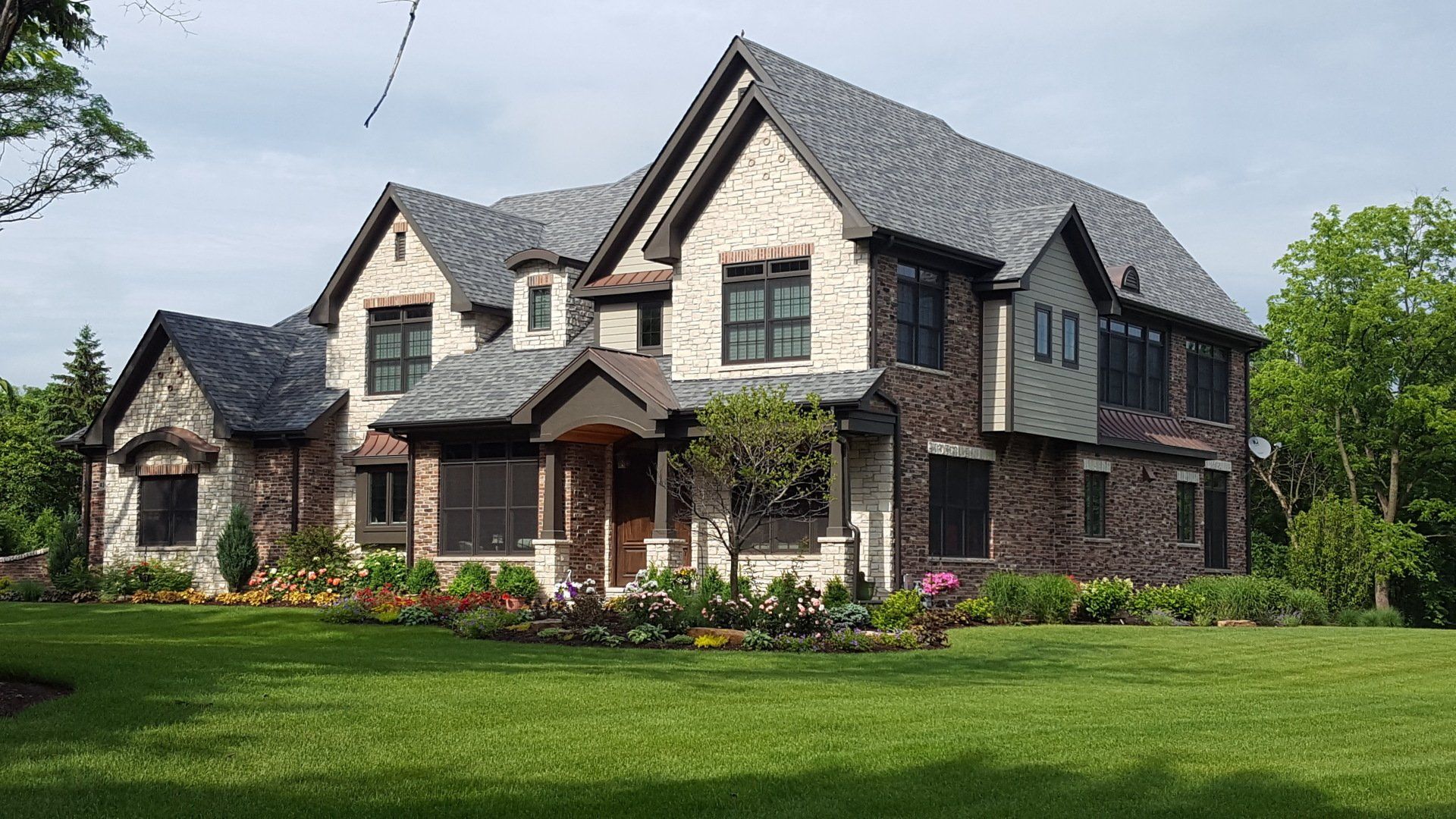 A large house with a lush green lawn in front of it