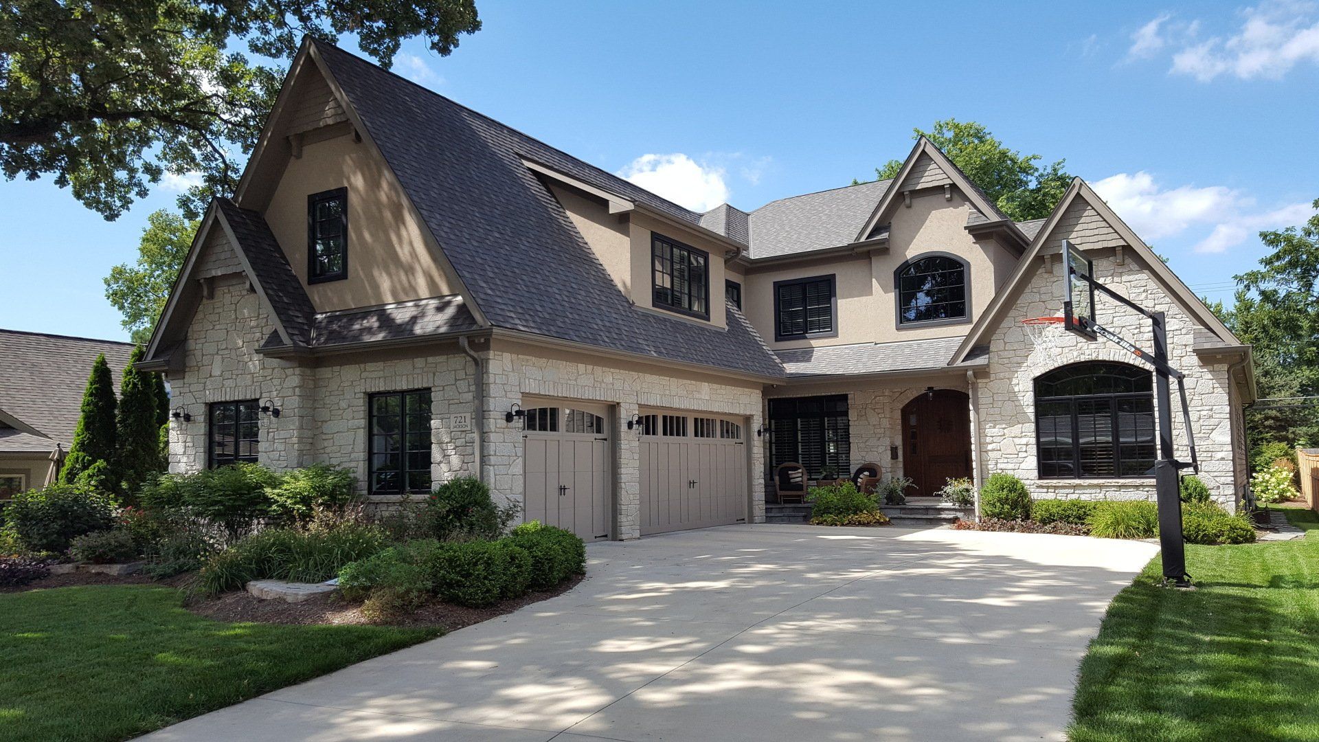 A large house with a lot of windows and a driveway