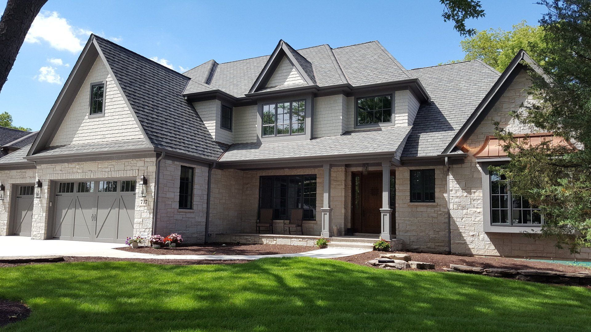 A large house with a gray roof and a lot of windows