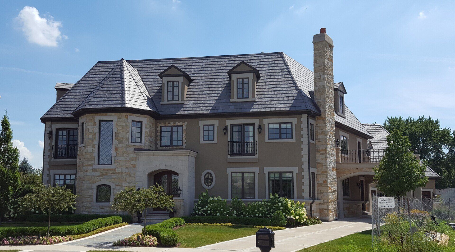 A large house with a lot of windows and a chimney