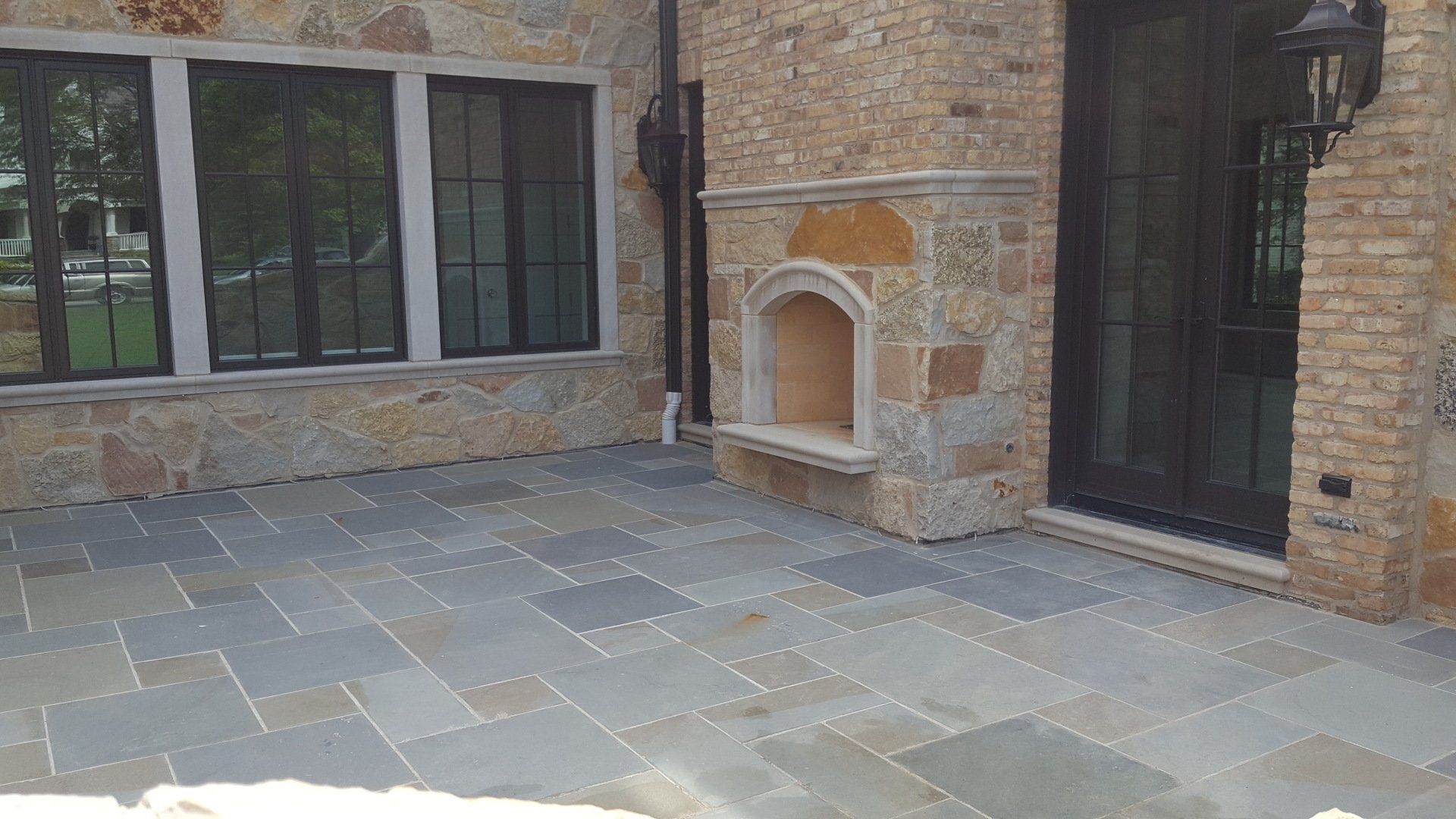 There is a fireplace in the backyard of a house.