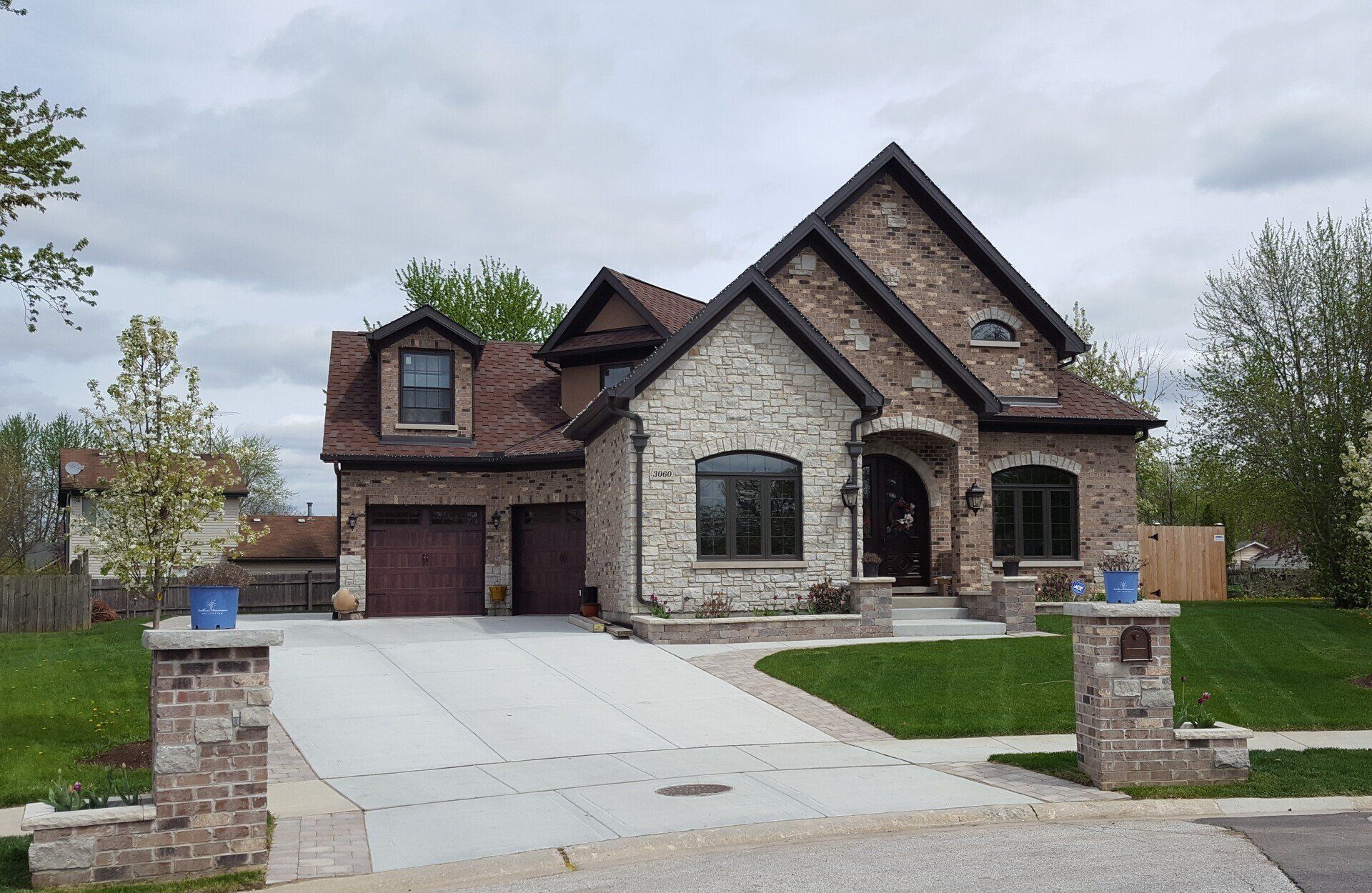 A large brick house with a driveway in front of it