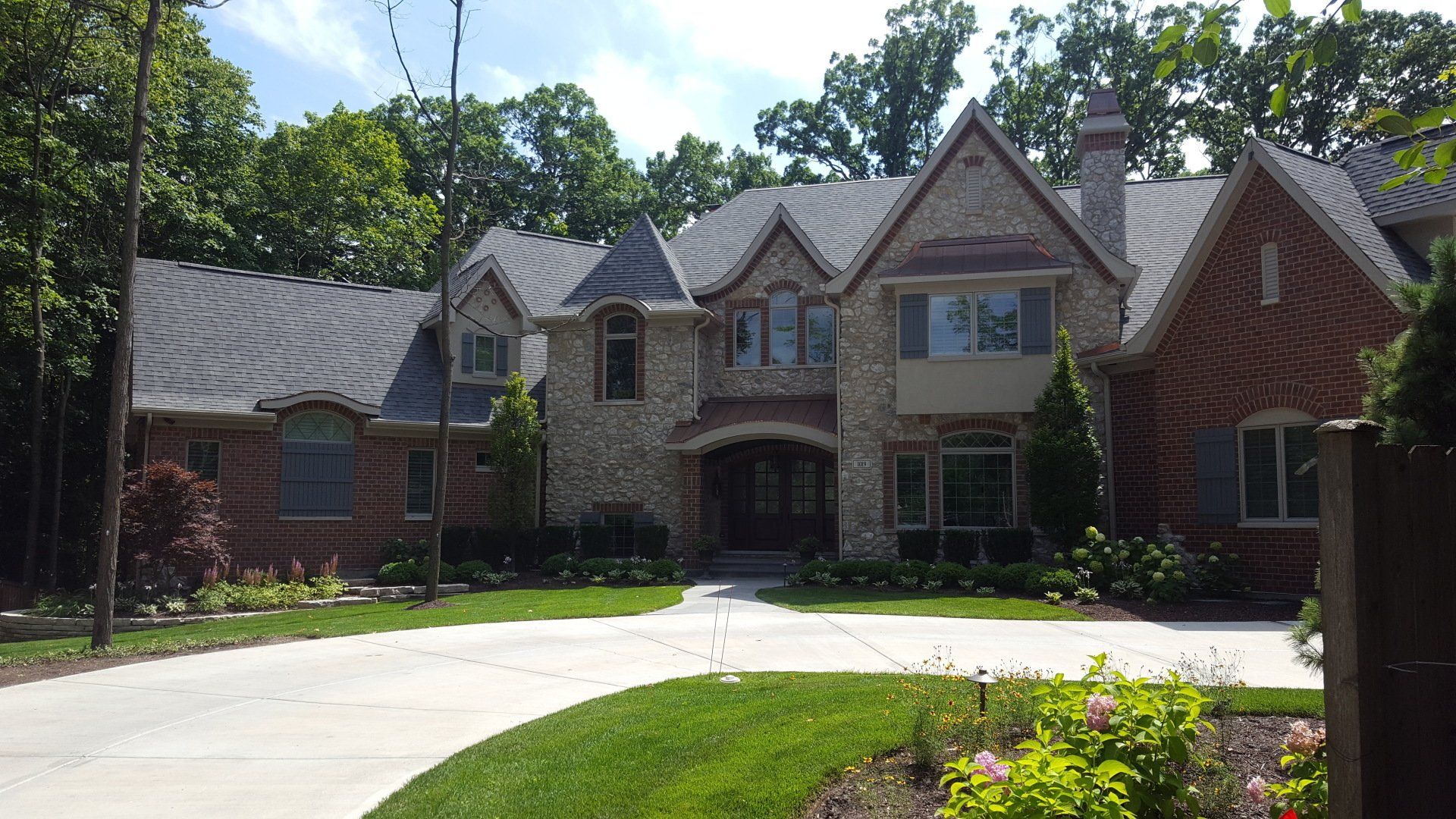 A large brick house with a driveway leading to it