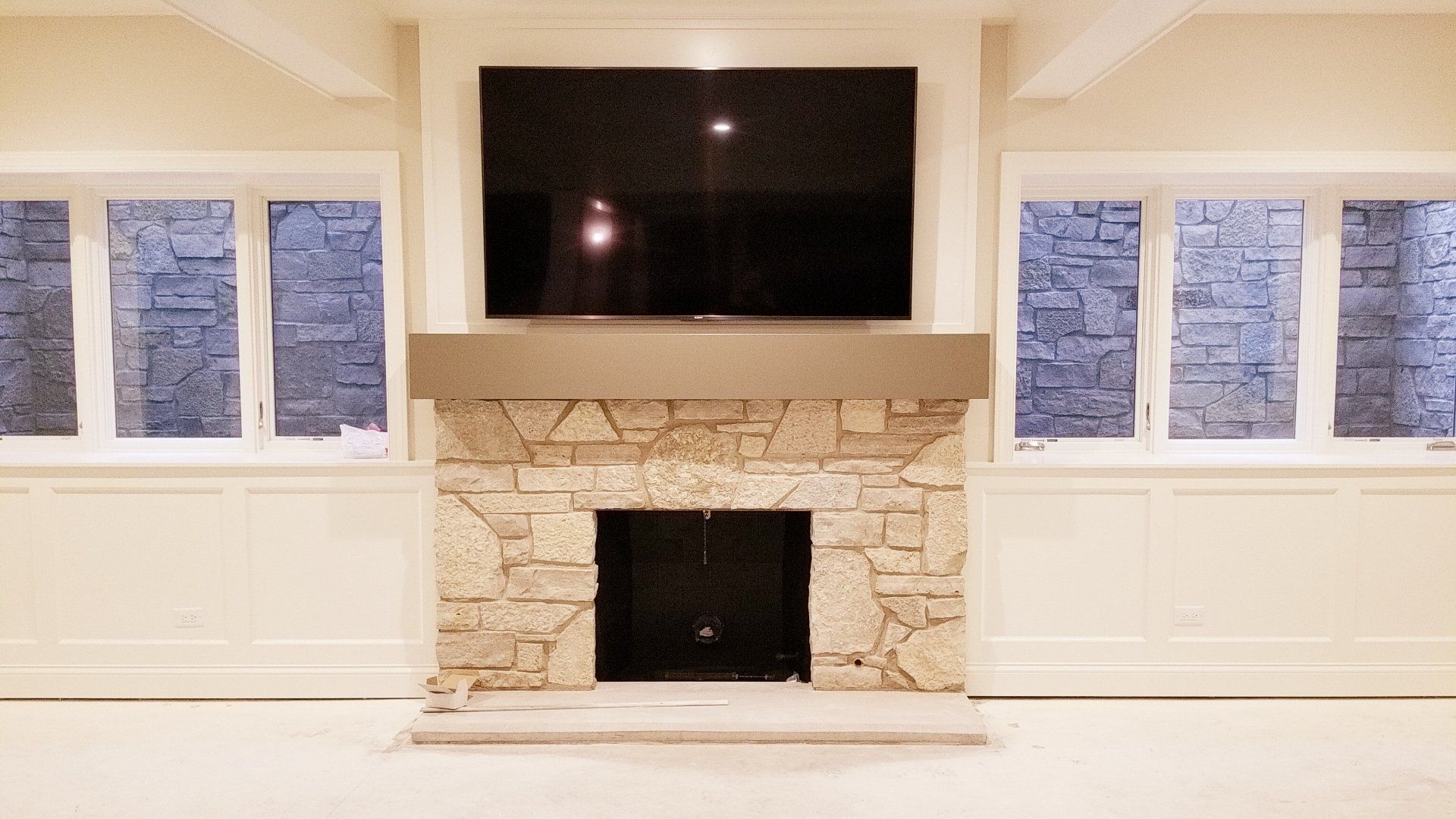 A living room with a fireplace and a flat screen tv above it.