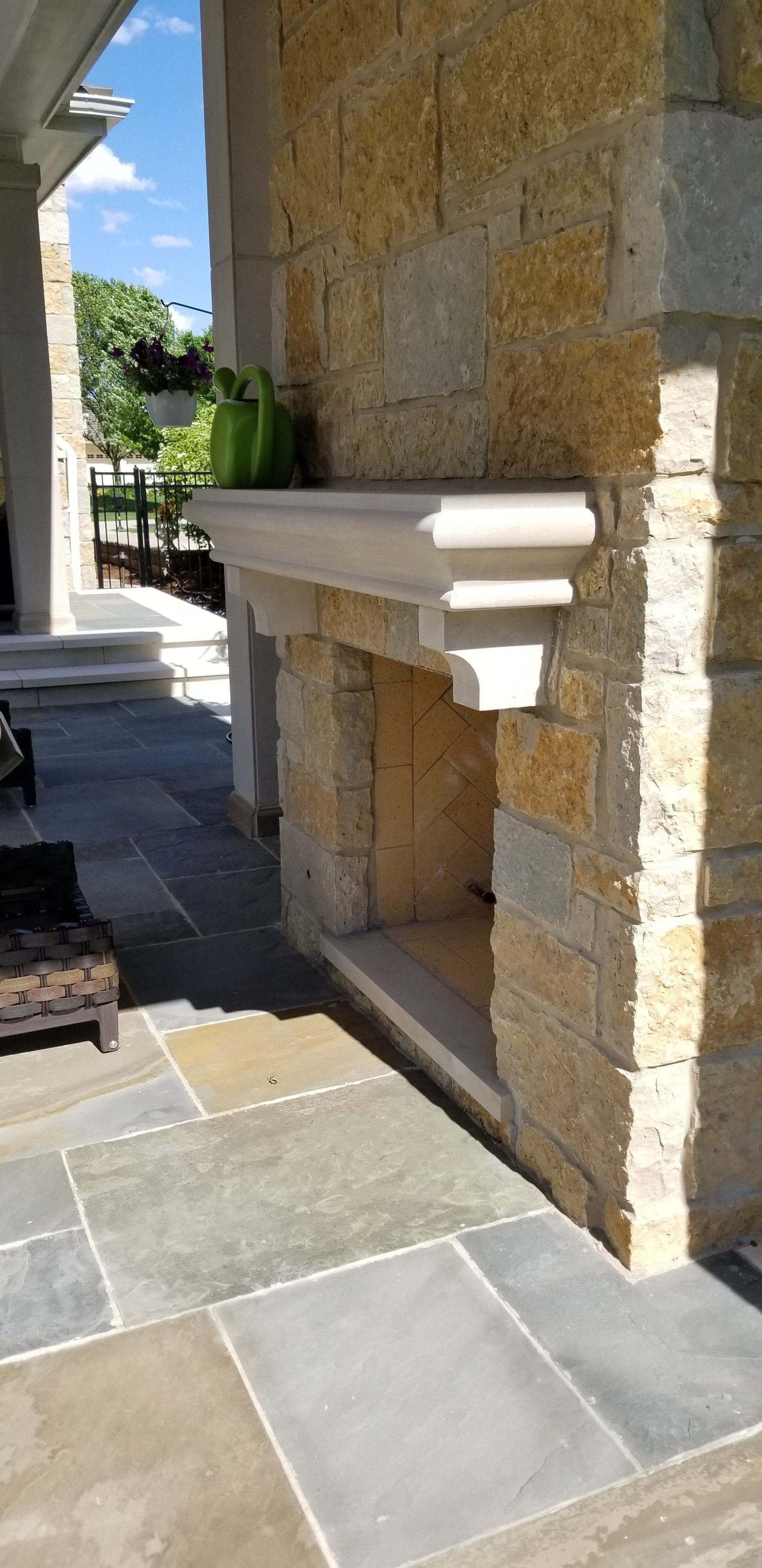 A fireplace is built into the side of a stone wall.