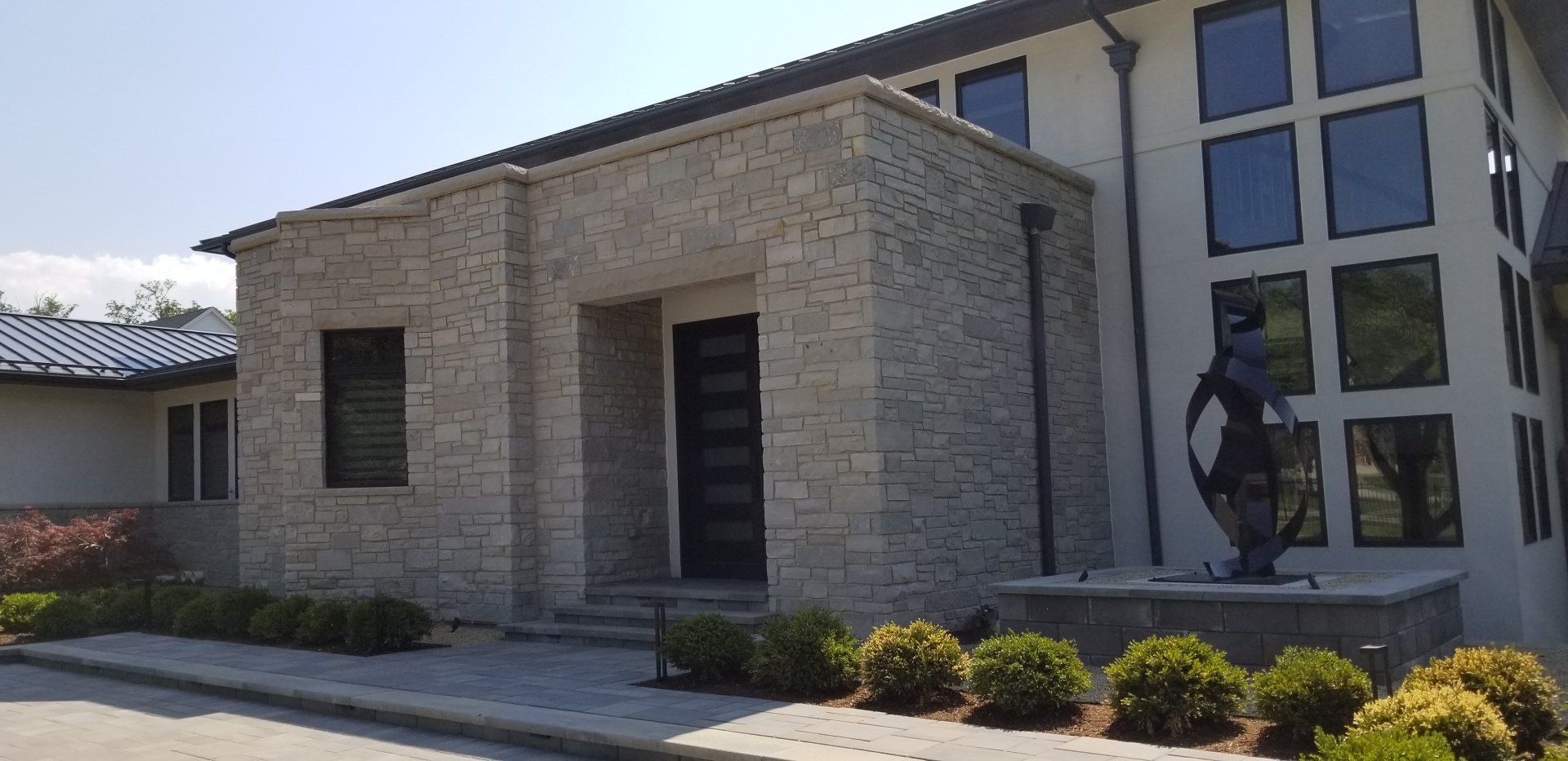 A large white house with a statue in front of it.
