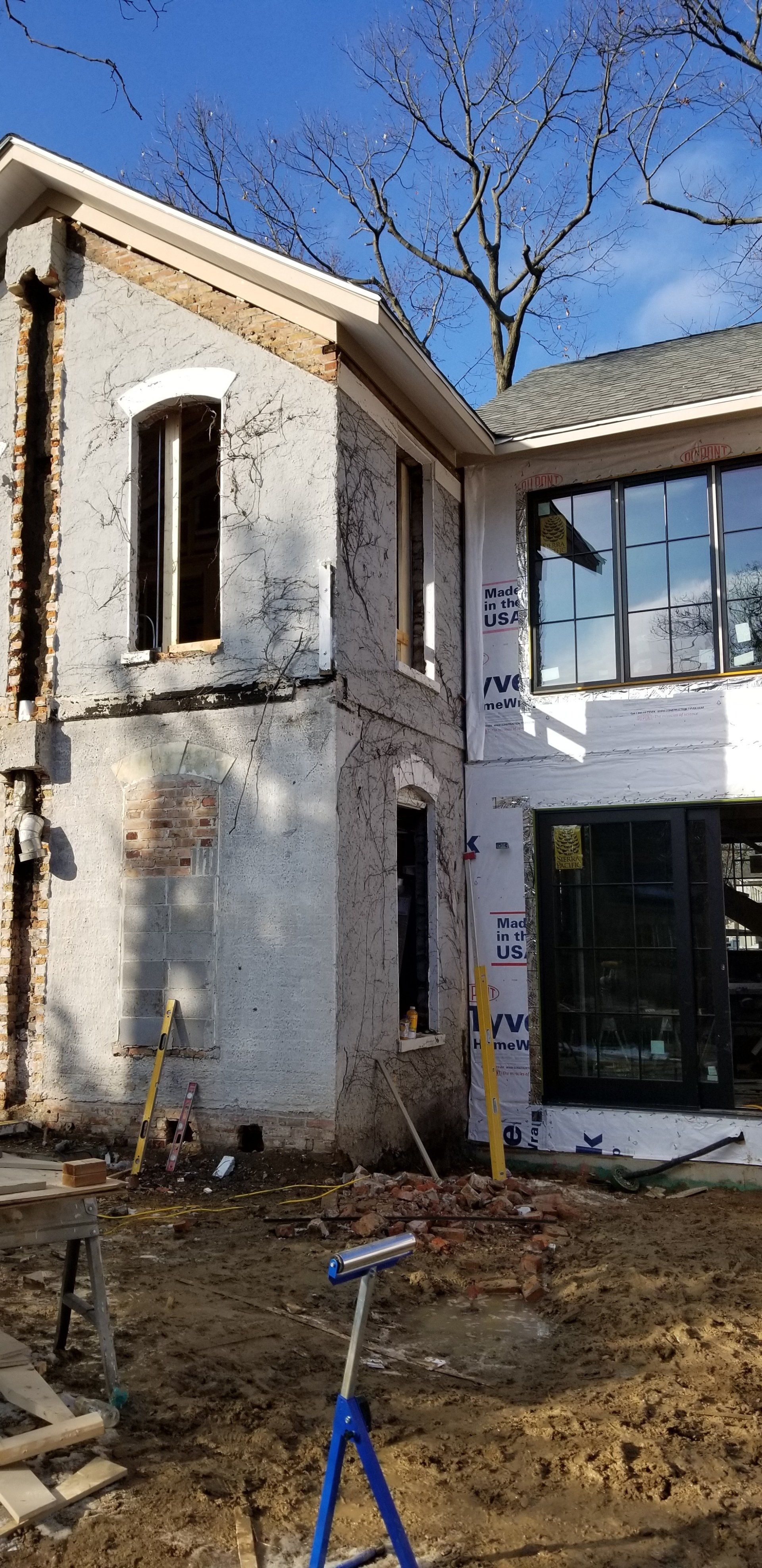 A large white house is being built with a lot of windows.