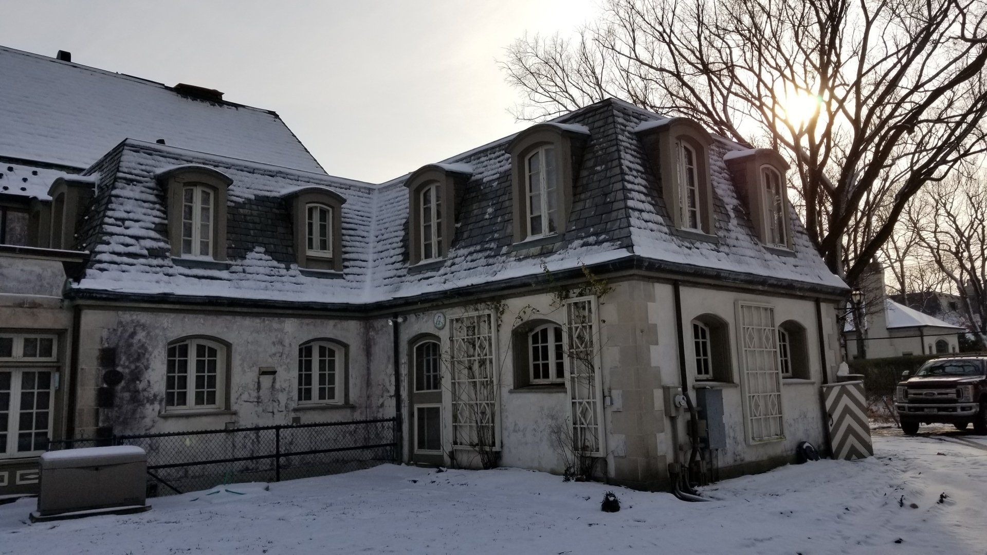 A large building with a lot of windows is covered in snow.
