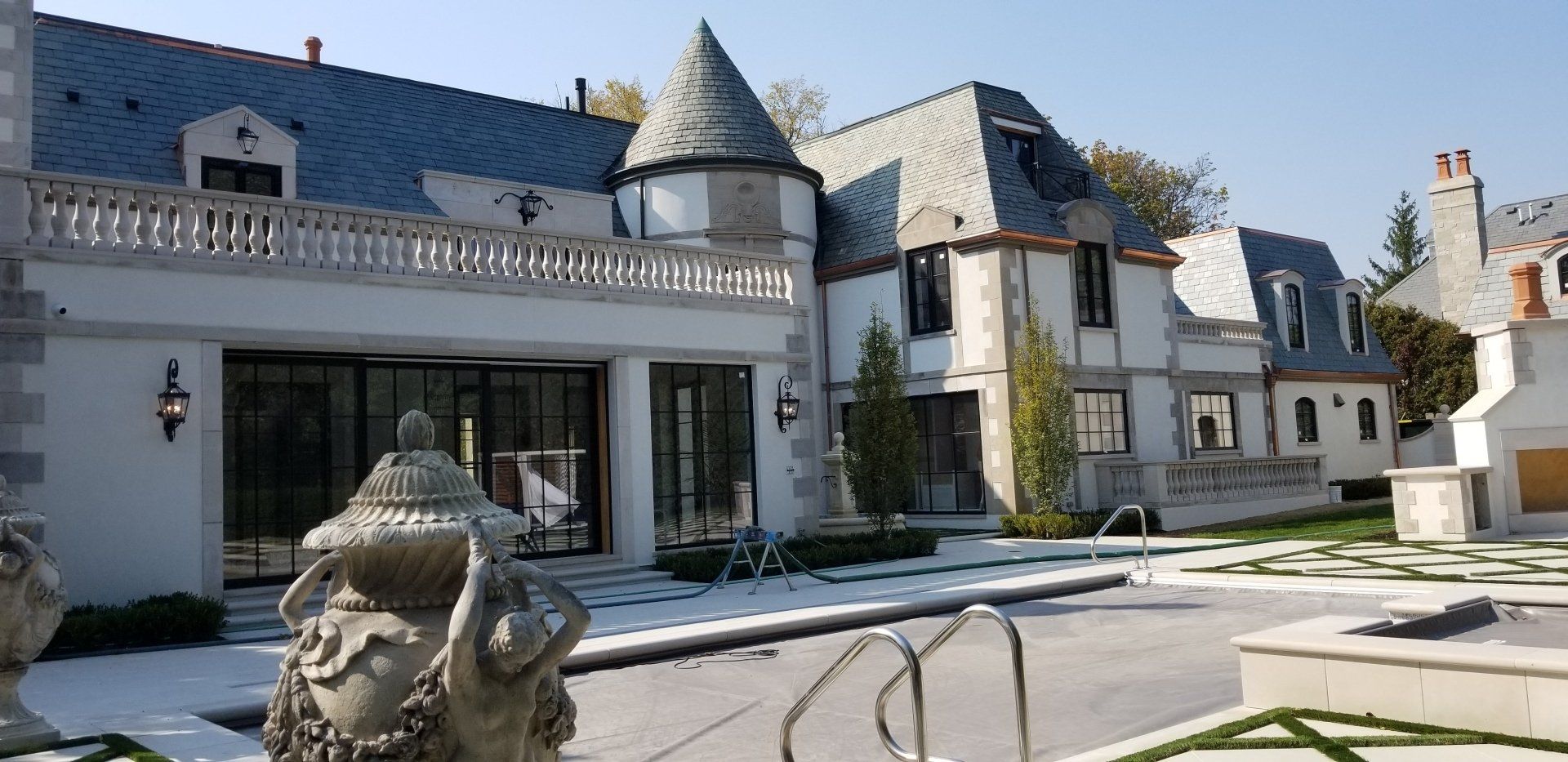 A large house with a pool in front of it