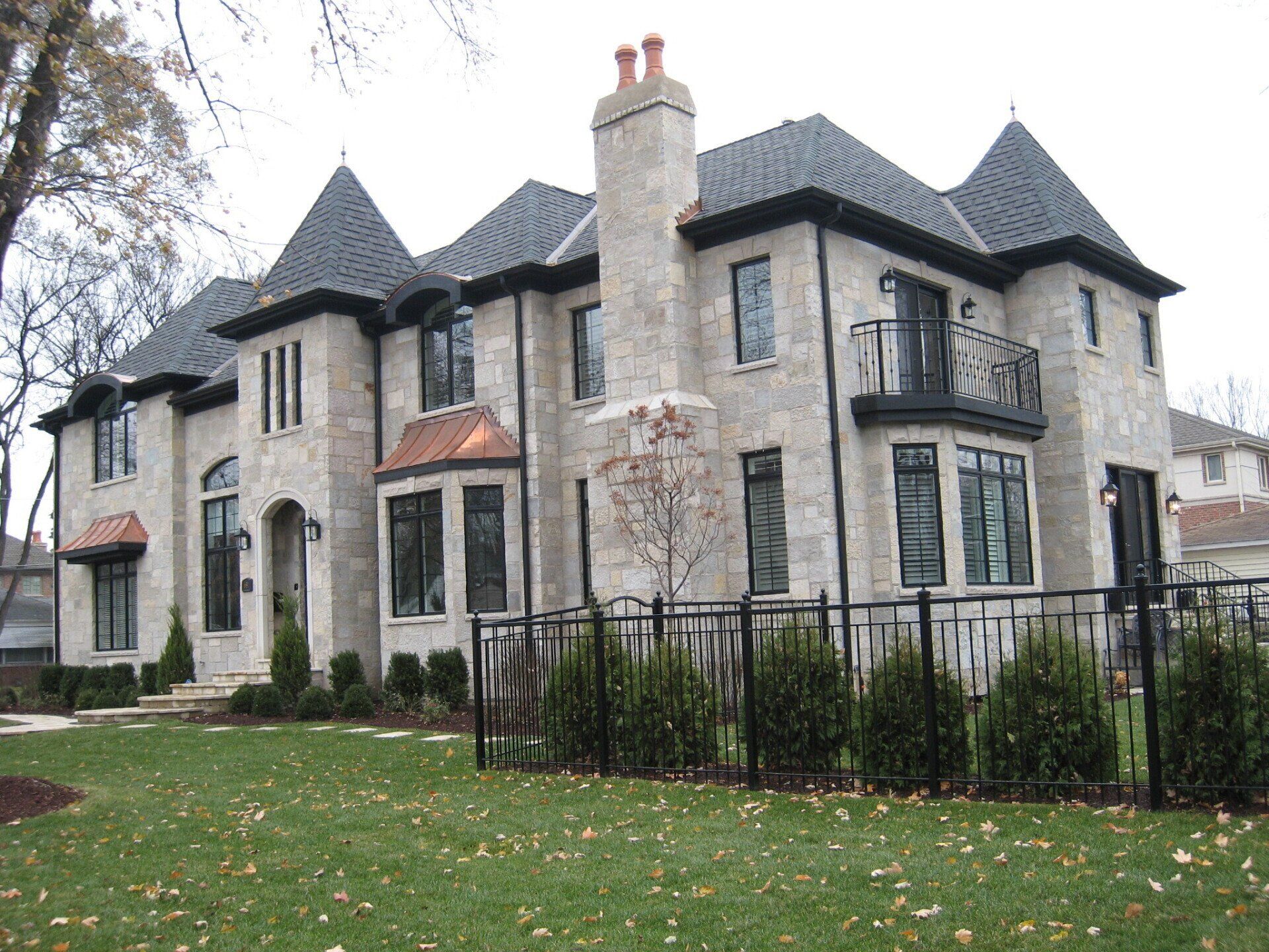 A large house with a black fence in front of it