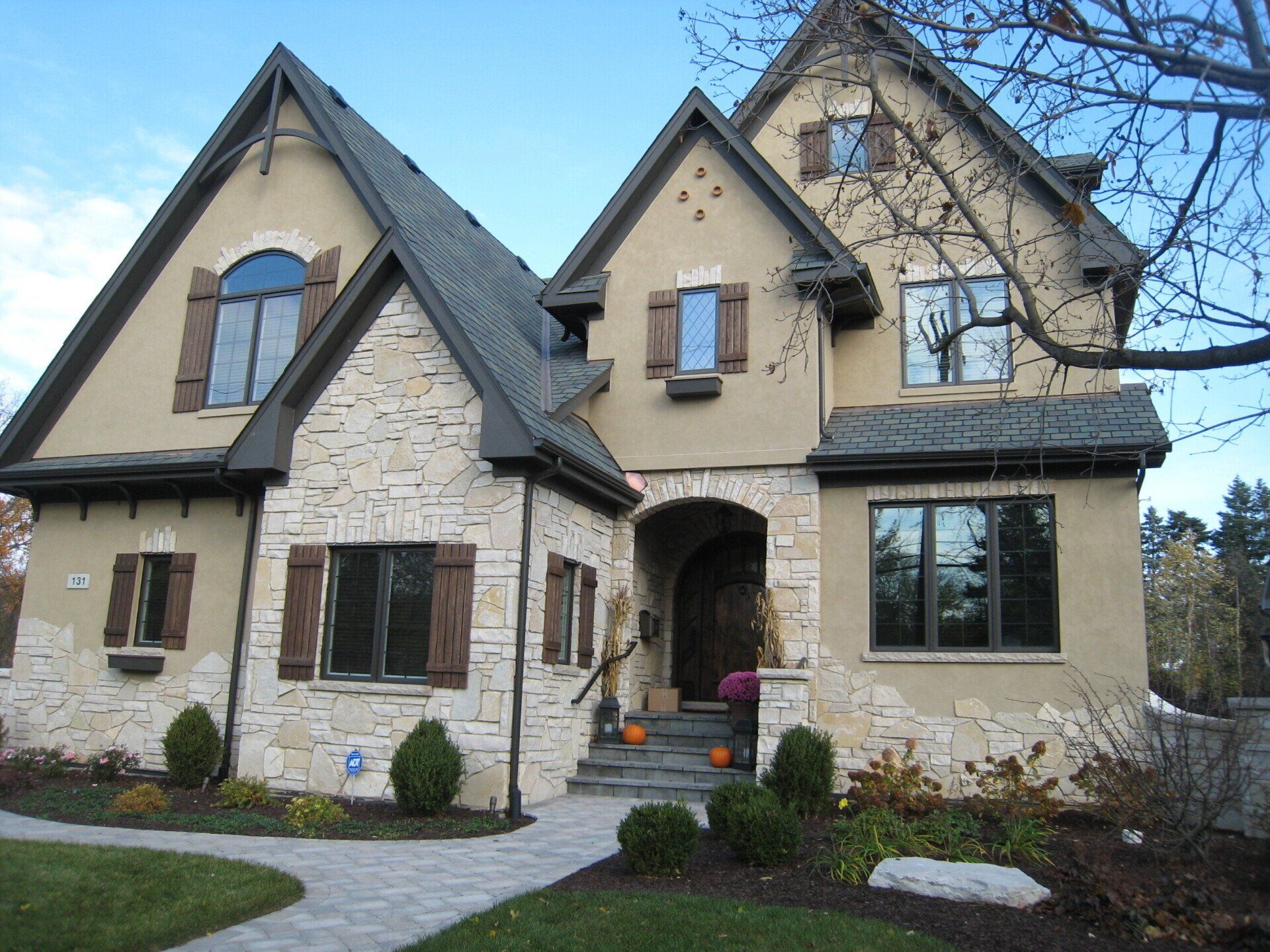 A large house with a lot of windows and shutters