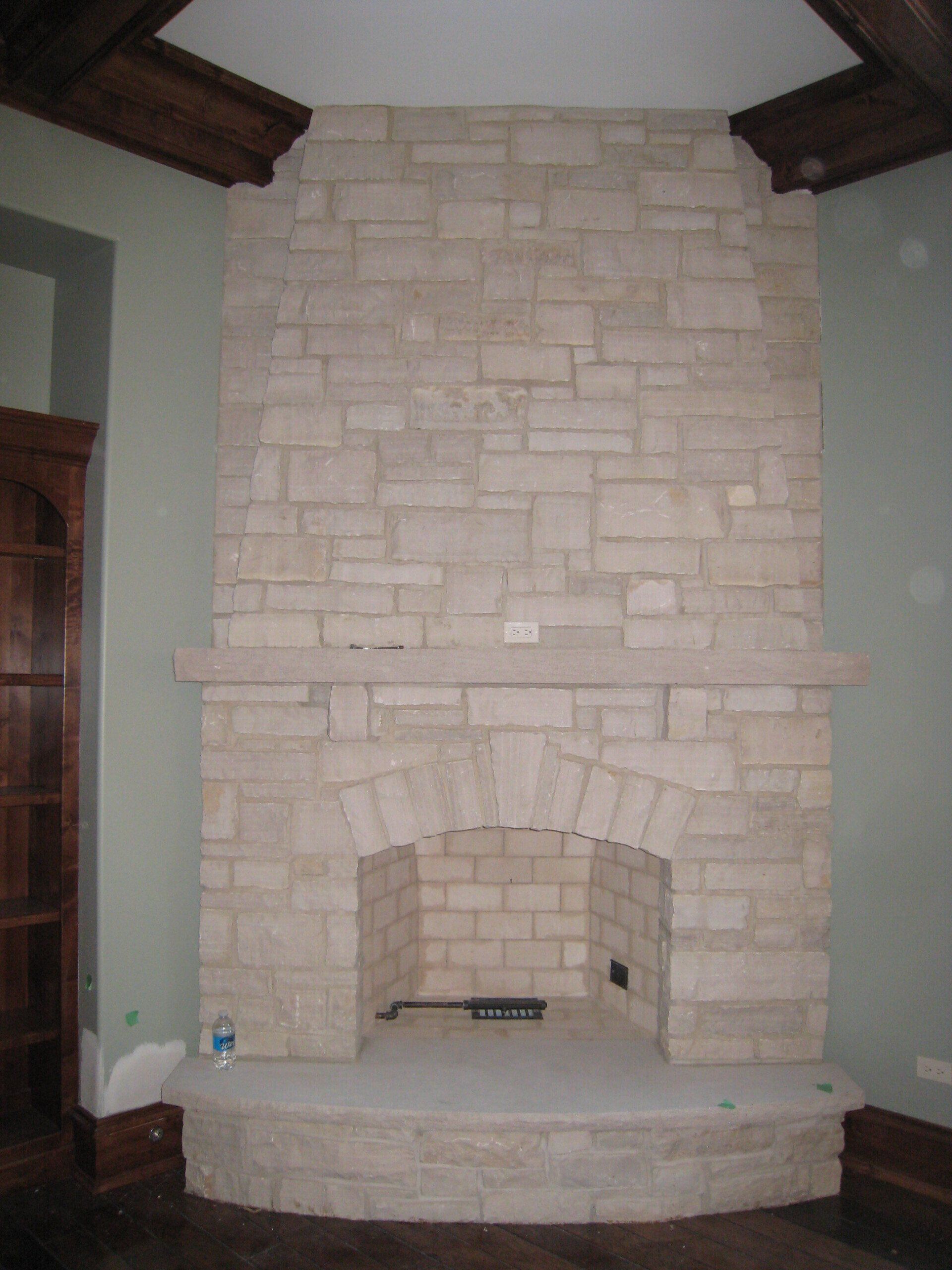 A large brick fireplace in a living room