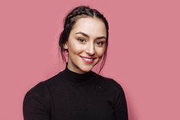 woman on pink background smiling